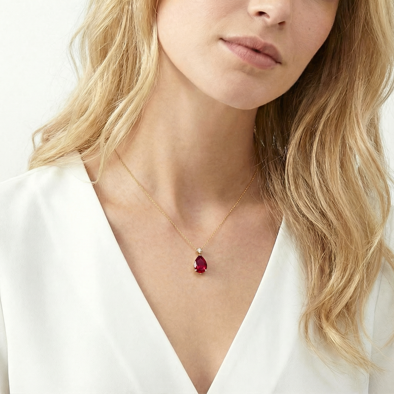 18K gold vermeil necklace with a teardrop simulated ruby pendant worn by a model.