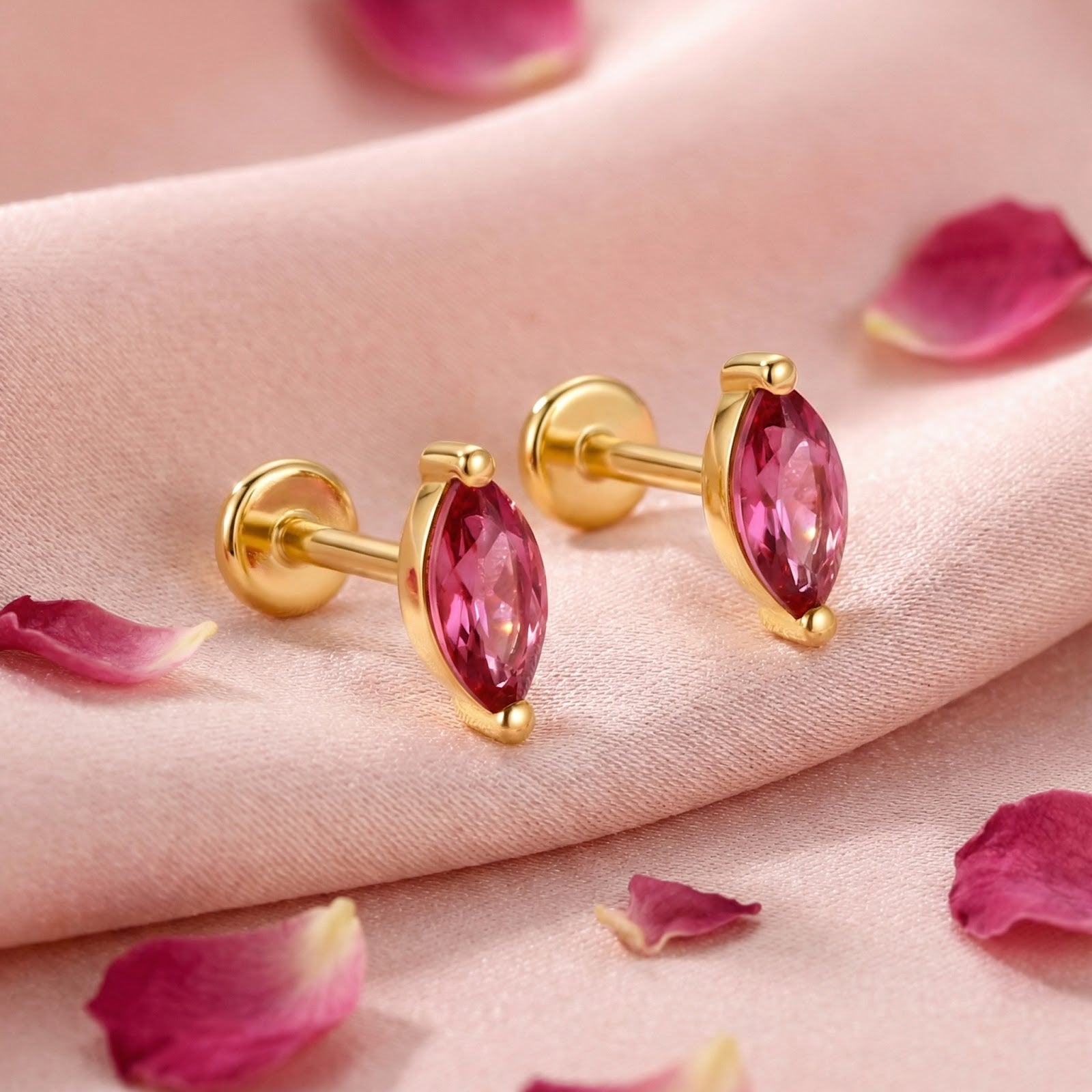 Marquise-cut pink tourmaline earrings in 18K gold vermeil with flat-back posts on pink silk with rose petals.