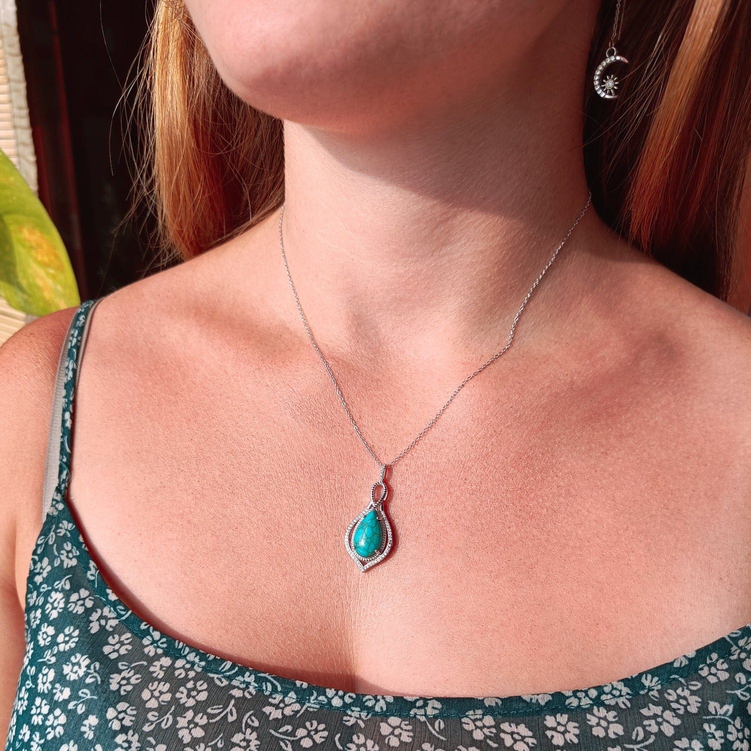 Mermaid's Turquoise Pendant Necklace featuring a turquoise stone set in S925 sterling silver on a model middle zoomed in natural sunlight