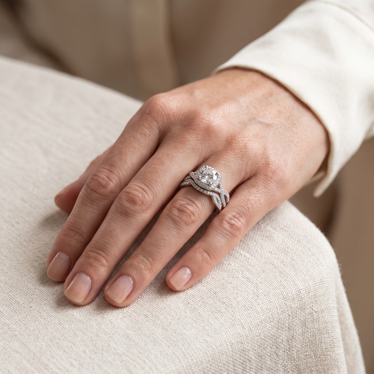Silver round halo bridal ring set worn on a model hand