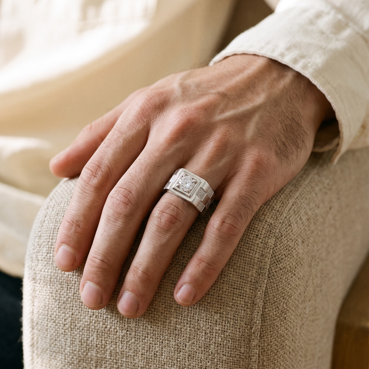 Silver checkered moissanite ring worn on a male model hand