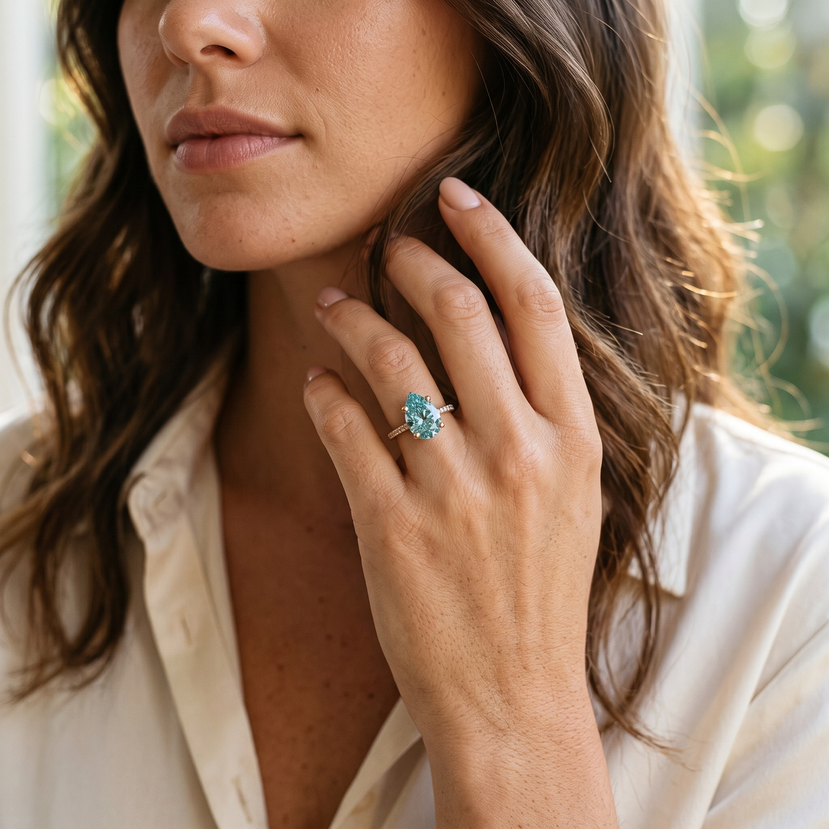 Marissa aqua-blue pear moissanite ring in rose gold, model portrait