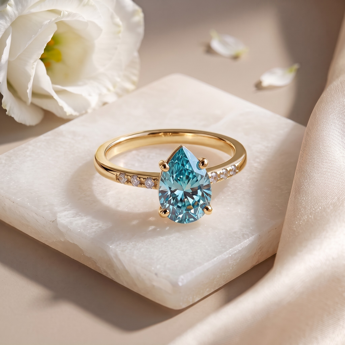 Marissa aqua-blue pear moissanite ring in yellow gold, isolated front view