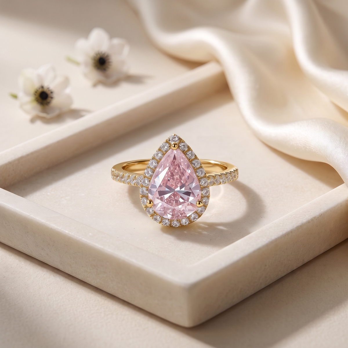 The Sabira pink pear moissanite halo ring in yellow gold, isolated product view