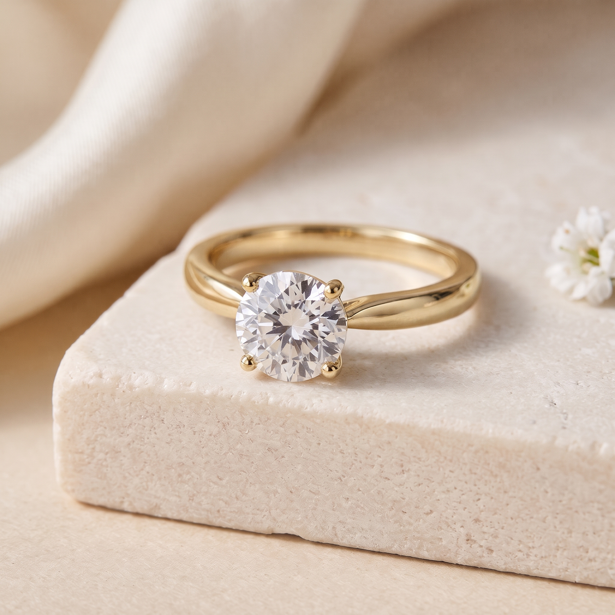 1CT brilliant round moissanite solitaire in yellow gold, isolated product view