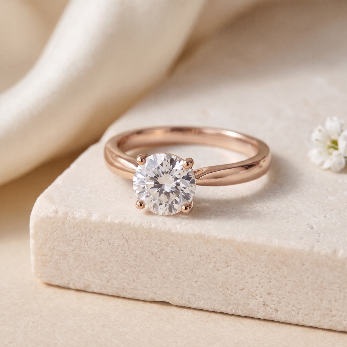 1CT brilliant round moissanite solitaire in rose gold, isolated product view