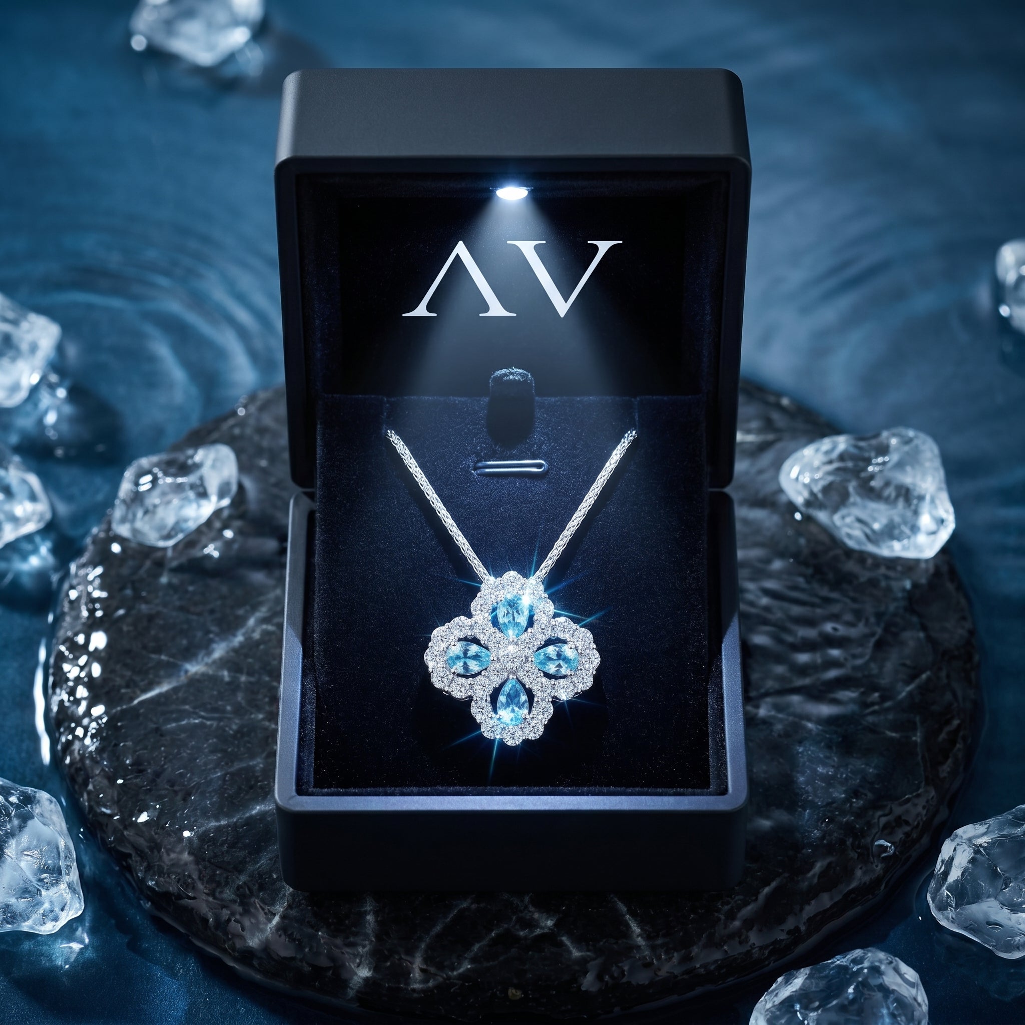 Pear cut aquamarine floral necklace in sterling silver presented in a premium lighted black gift box.
