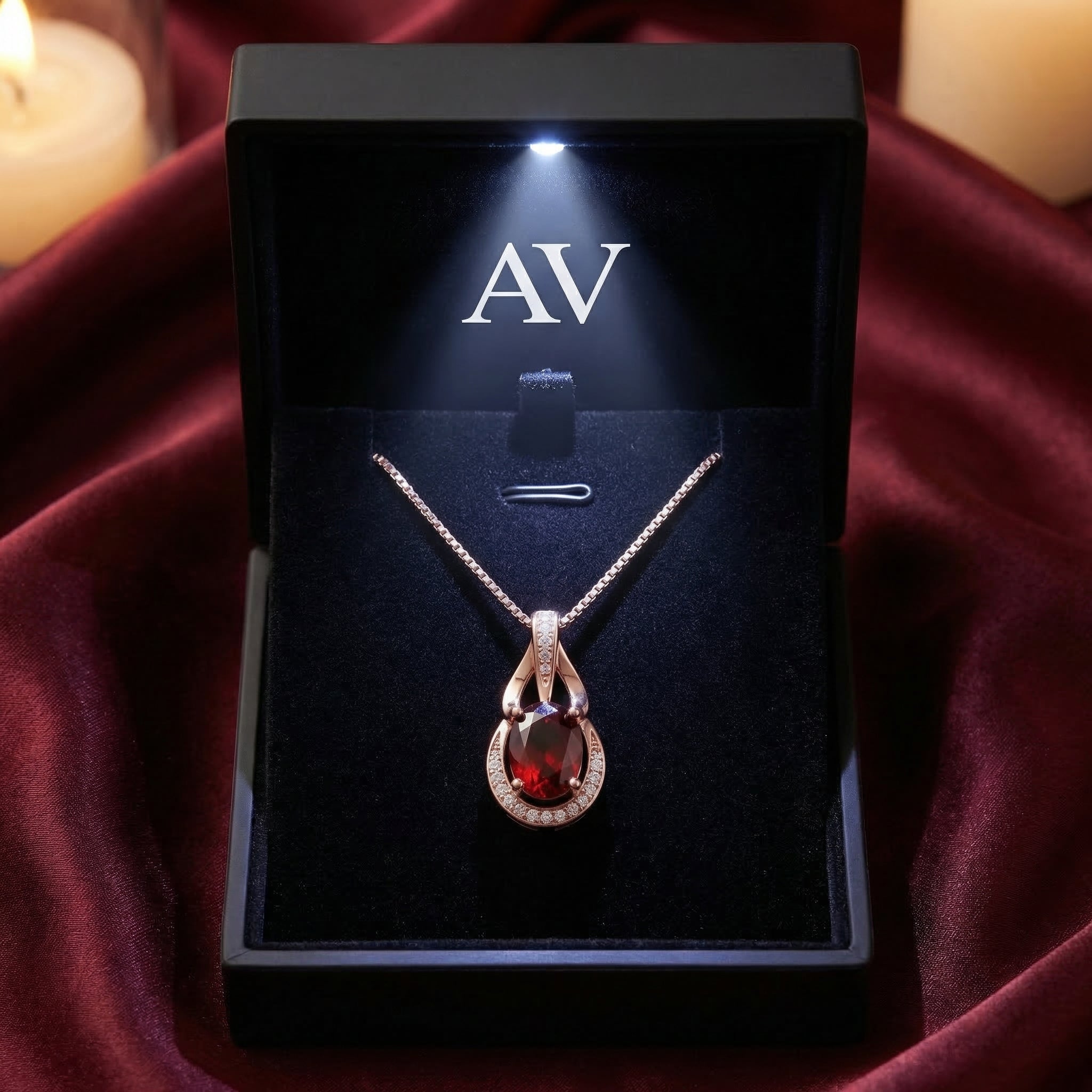 18K rose gold oval garnet necklace in a premium lighted black jewelry box with AV logo.