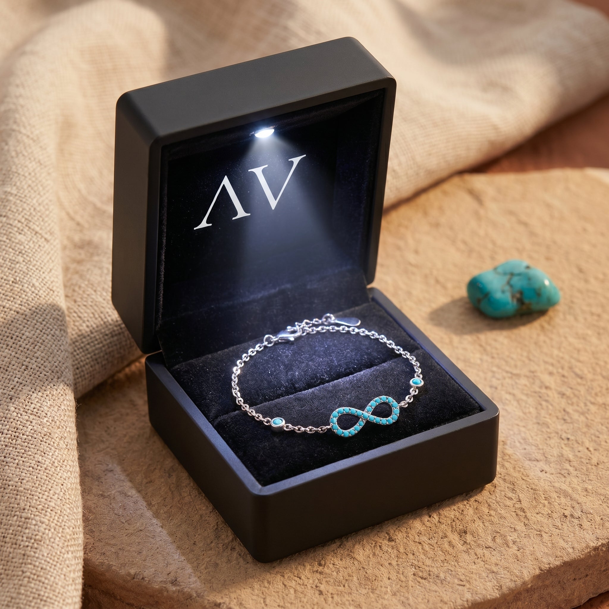 Silver turquoise infinity bracelet inside a premium black gift box with an integrated LED light.