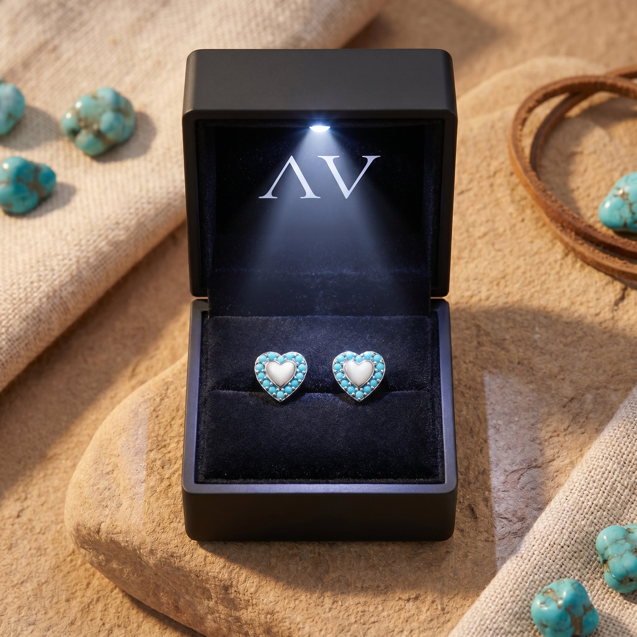 Sierra heart turquoise earrings presented in a black LED-lighted jewelry gift box on a desert-themed background.