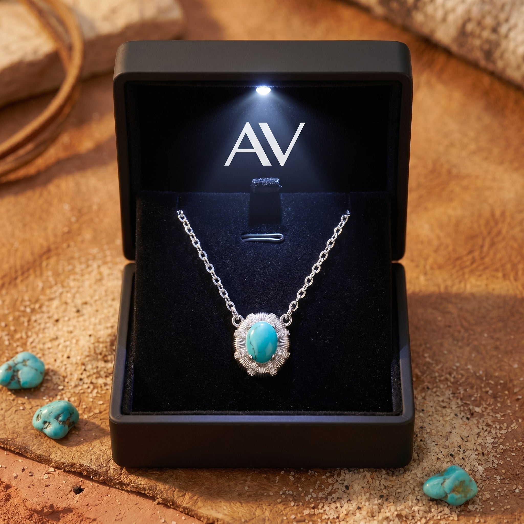 Silver Arizona turquoise necklace with an oval cabochon in a starburst bezel, presented in a lighted black gift box.