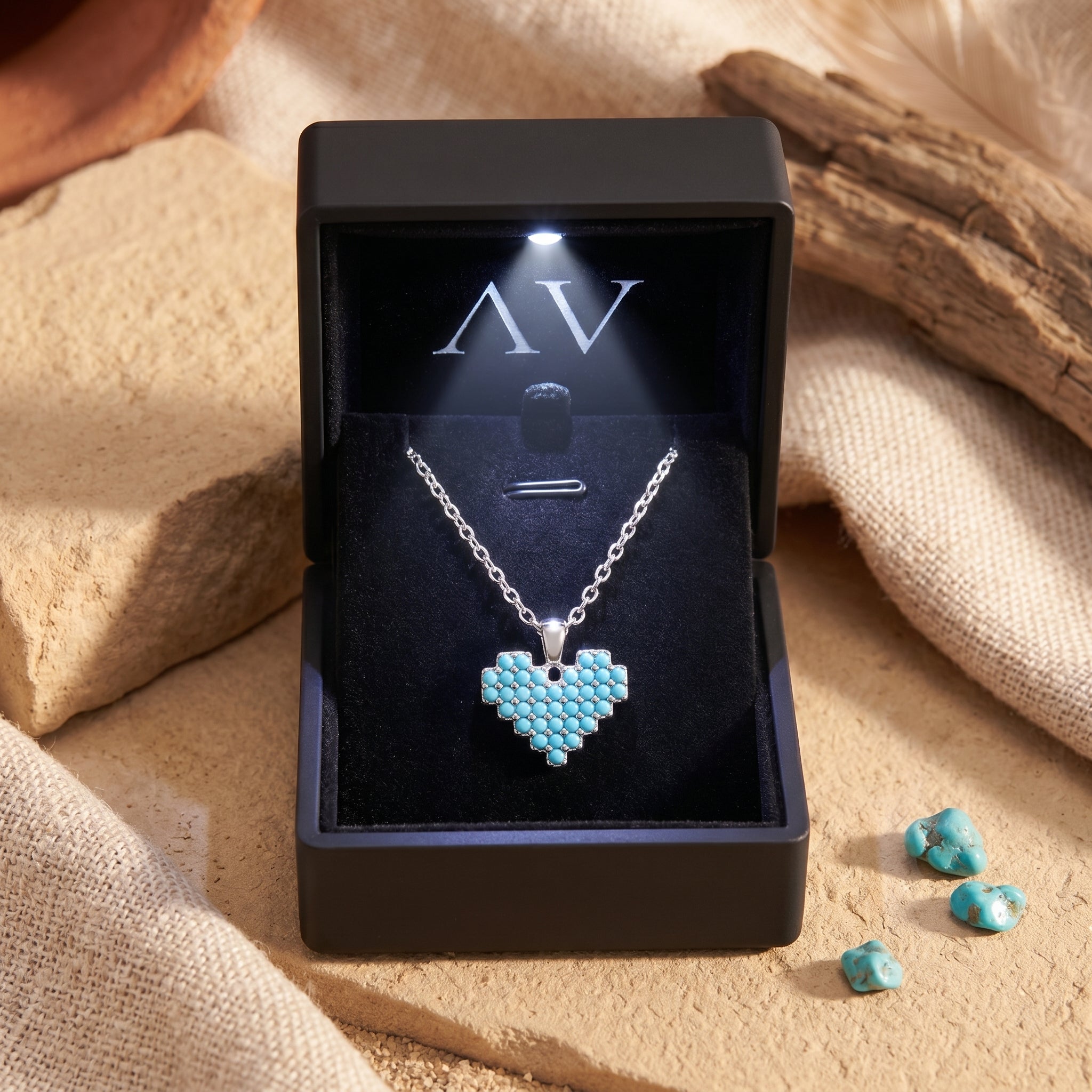 Silver Sedona Heart Turquoise Necklace presented in a black LED-lit jewelry gift box on a desert-styled surface.