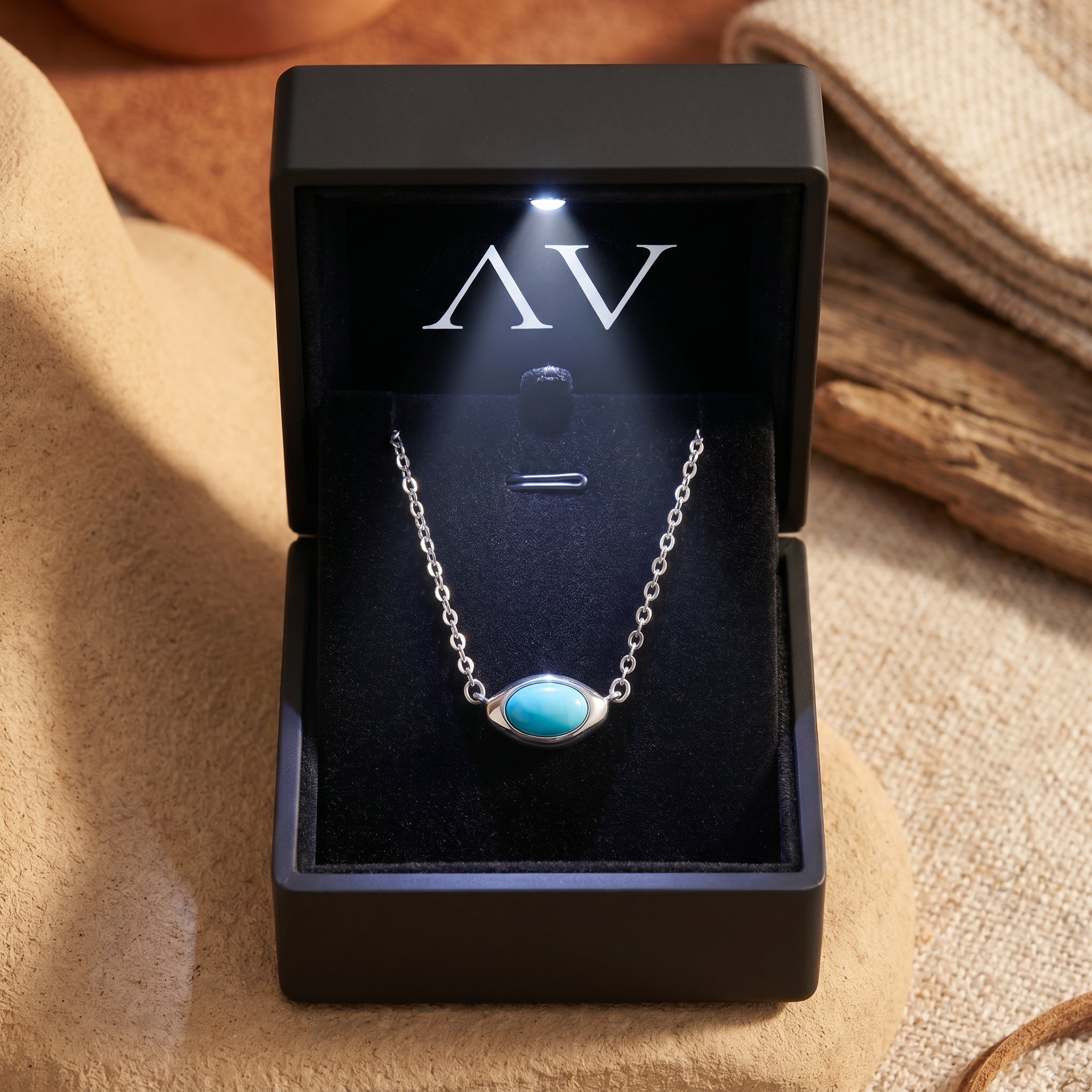 Silver turquoise necklace presented in a premium black LED-lit jewelry gift box with branded AV logo.