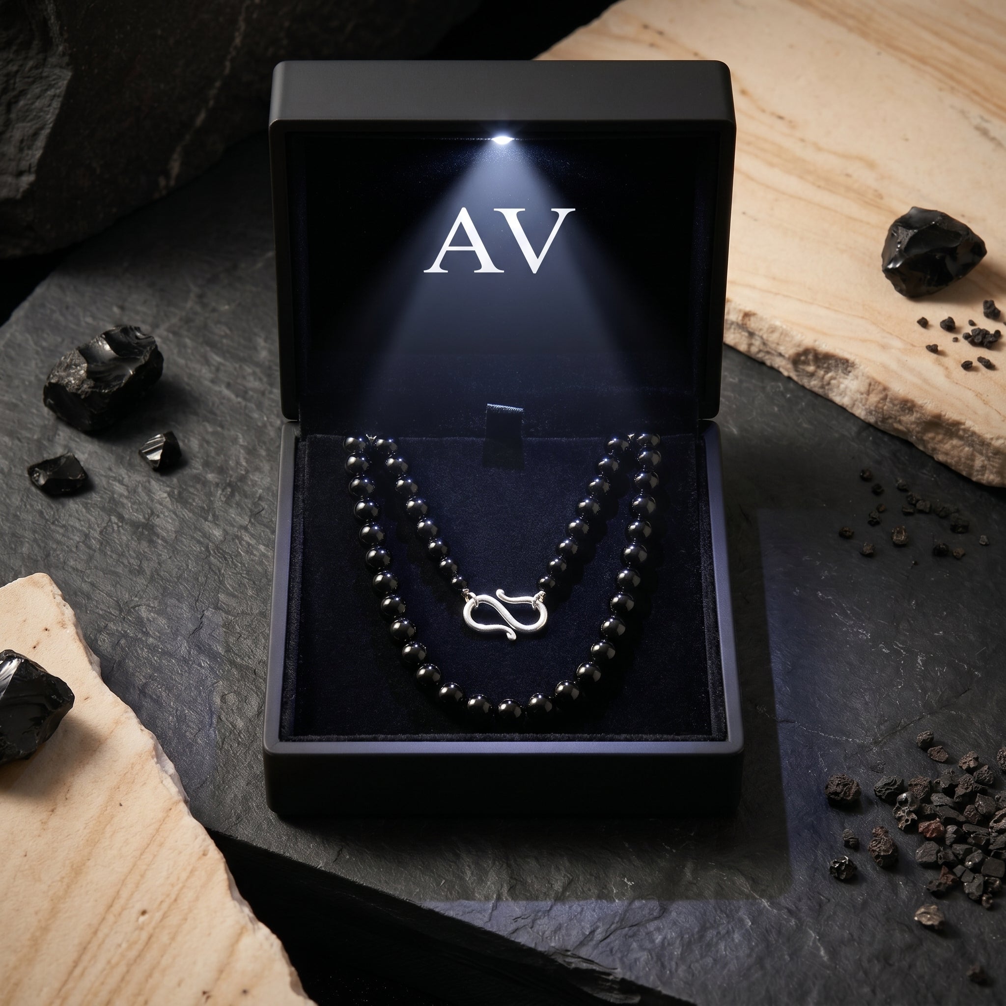 6mm black onyx beaded necklace with silver clasp inside a lighted black AV jewelry presentation box.