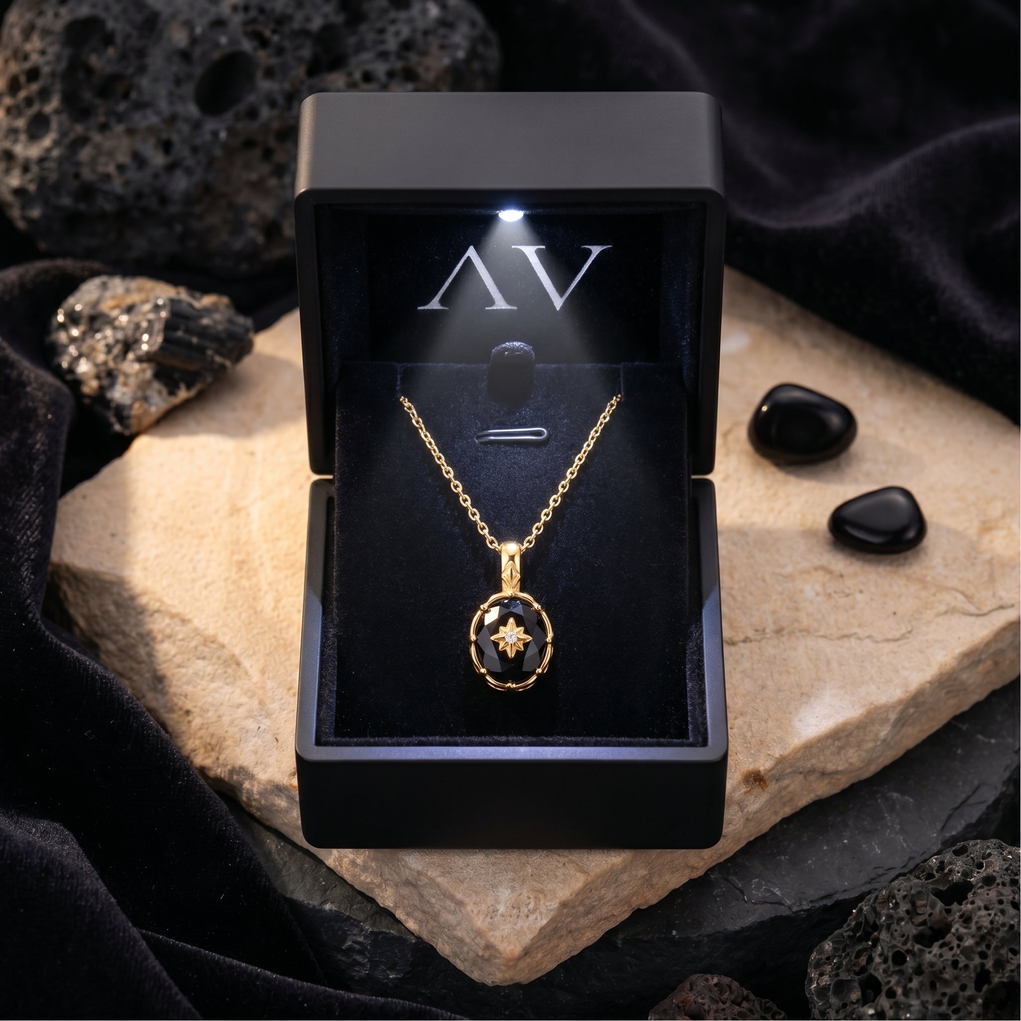 The Monarch oval-cut black onyx pendant necklace in 18K gold plating inside a black LED-lit gift box.