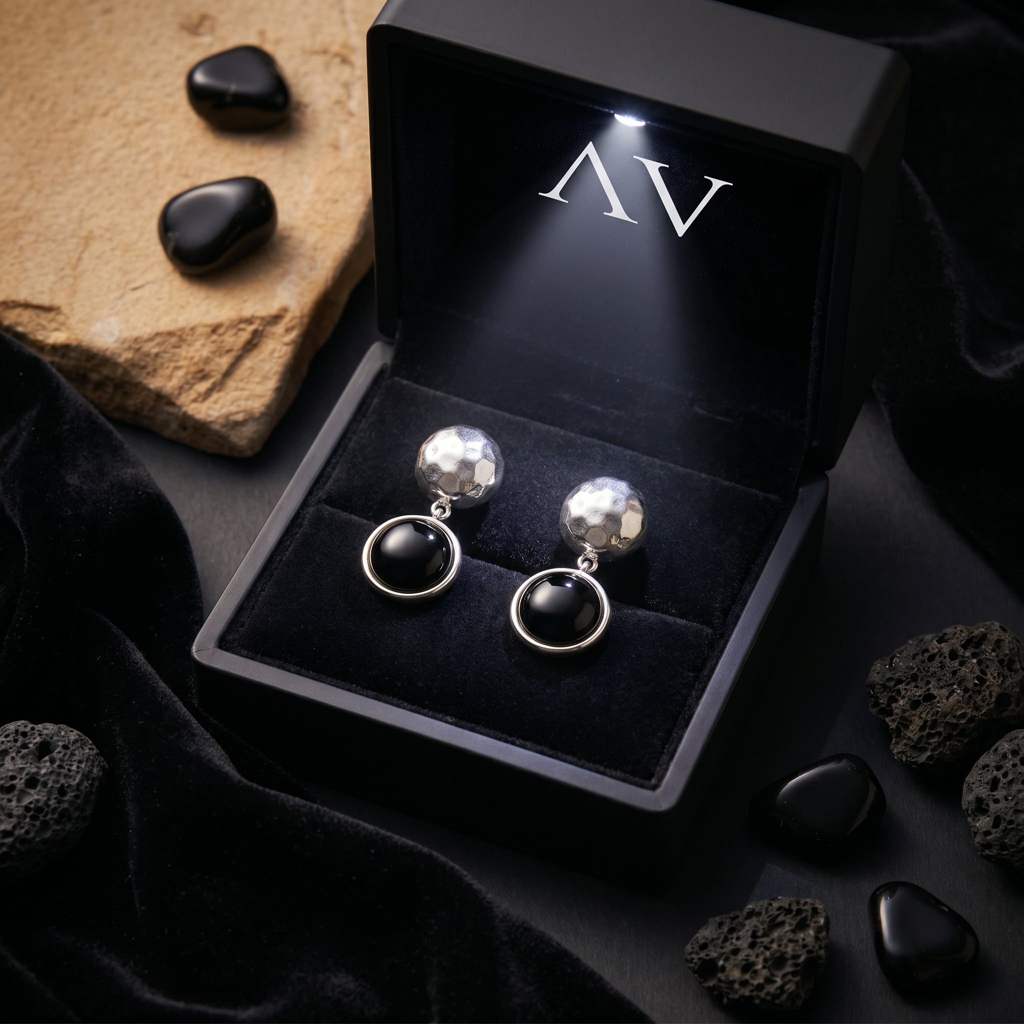 Sereia silver and black onyx drop earrings presented in a black illuminated jewelry gift box.
