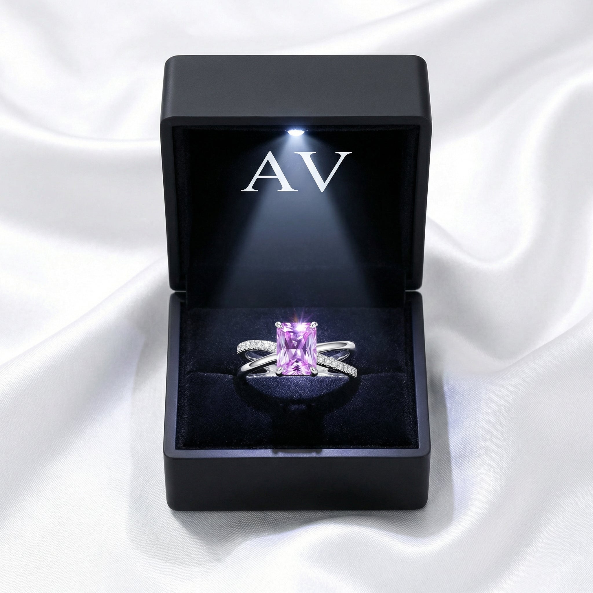 The Evanthe sterling silver amethyst ring presented in a black LED-lit jewelry box on white silk.