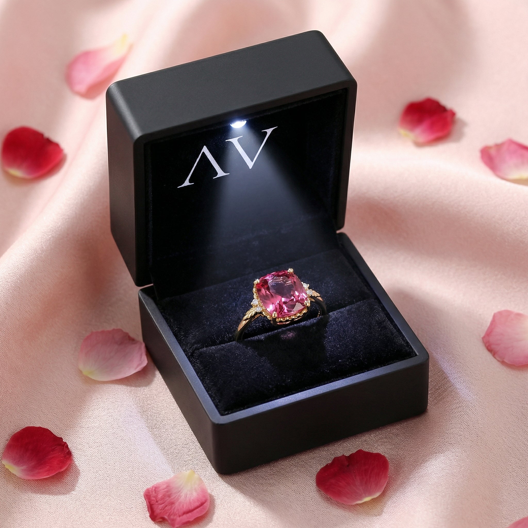 Cushion cut simulated pink tourmaline gold vermeil ring inside a black lighted jewelry presentation box.