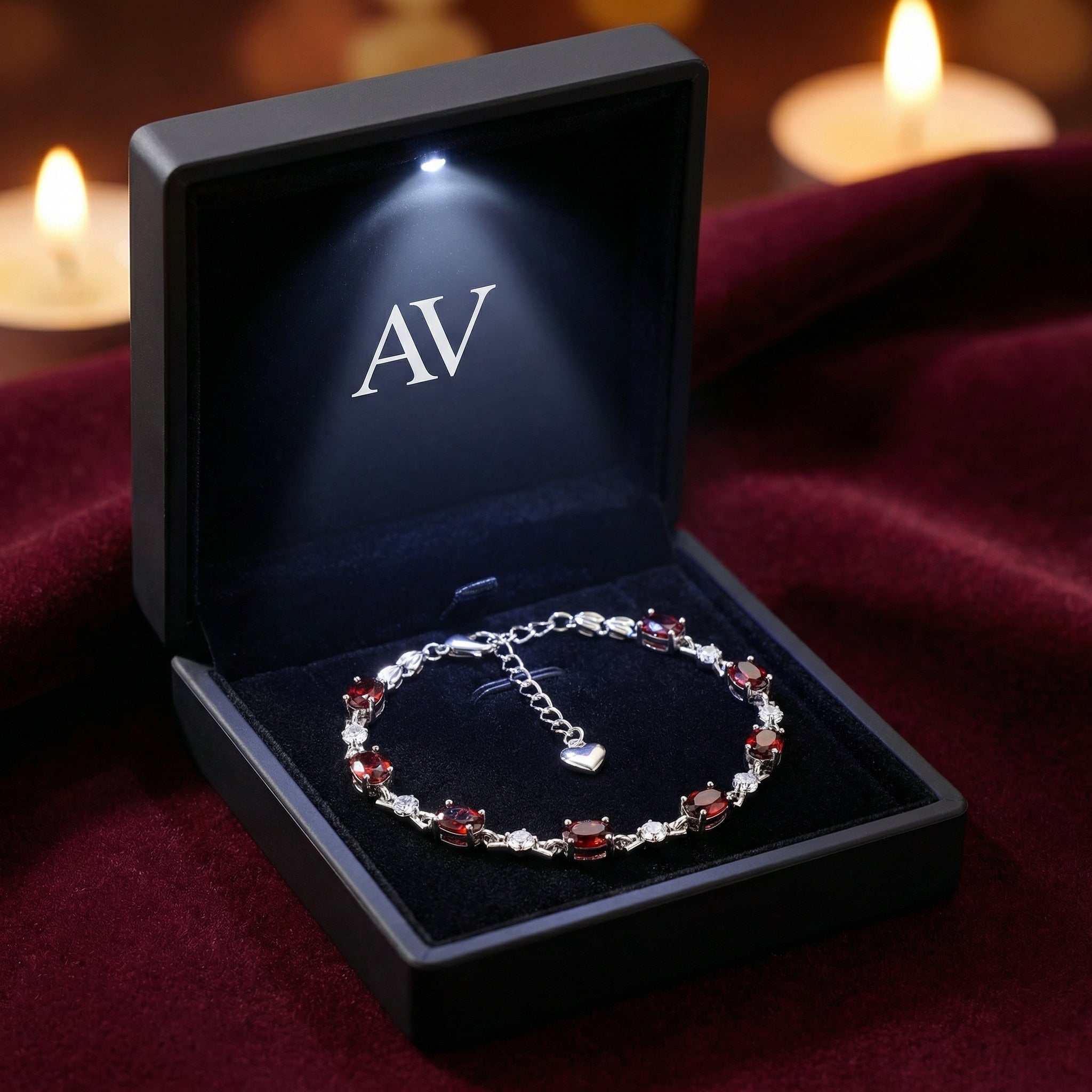 Melora simulated garnet bracelet inside a black LED-lighted jewelry gift box on red velvet.