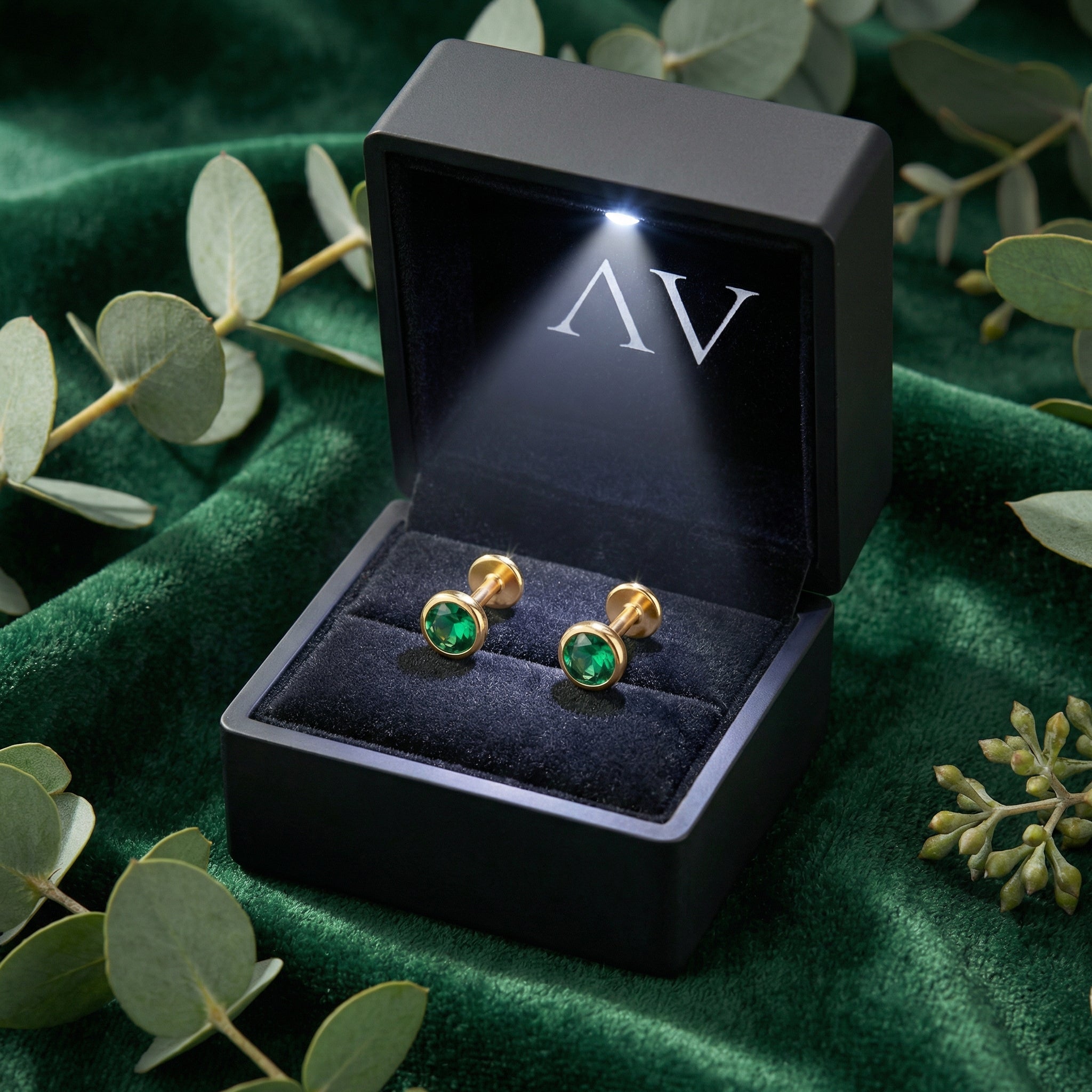 Round simulated emerald bezel stud earrings in 18K gold vermeil inside a black LED-lighted jewelry gift box.