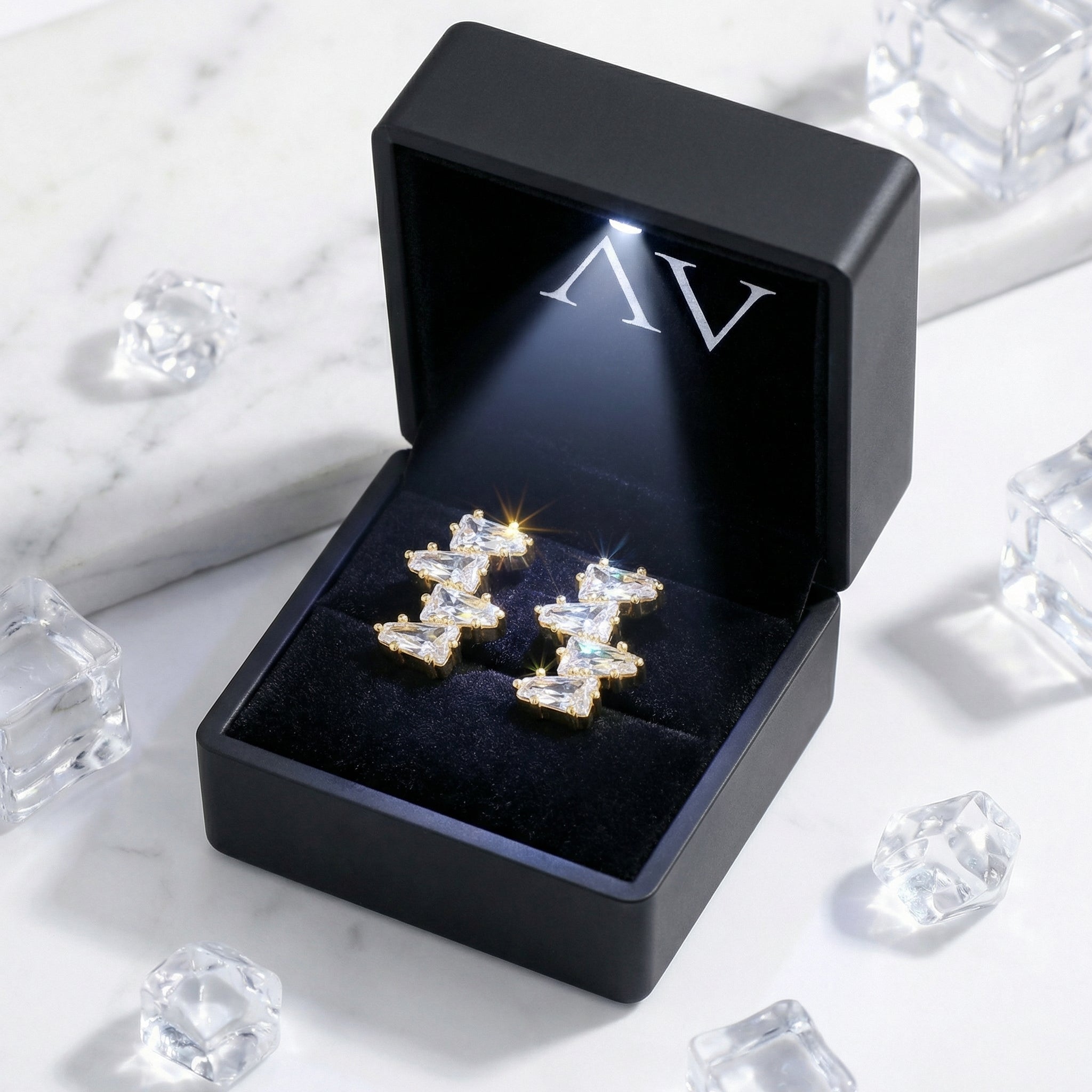 18K gold vermeil Alizia cluster earrings presented in a black LED-lit branded jewelry gift box.