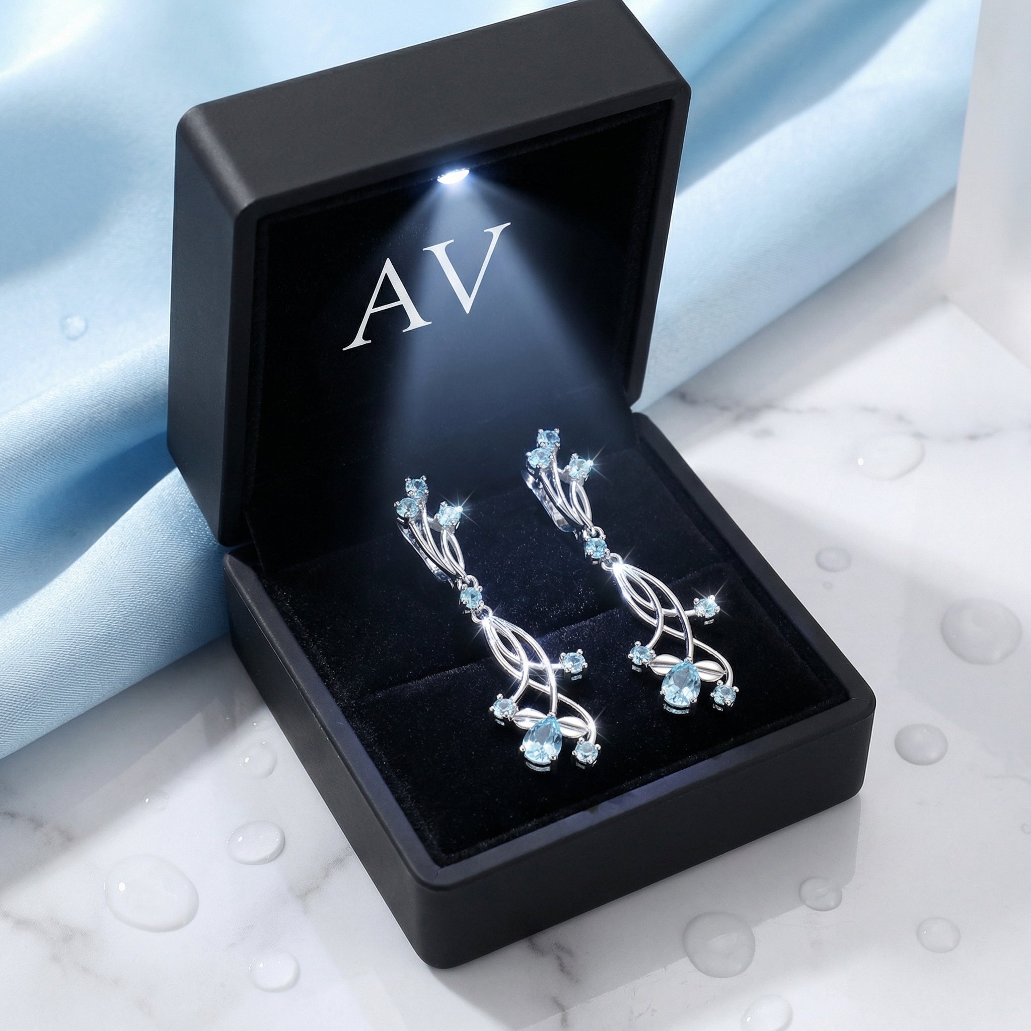 S925 sterling silver simulated aquamarine drop earrings presented in a black lighted jewelry gift box.