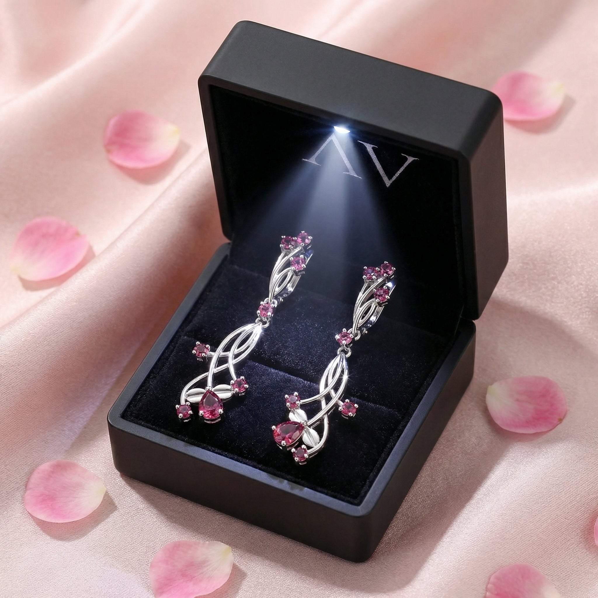 Sterling silver pink tourmaline vine drop earrings presented in a lighted black jewelry gift box.