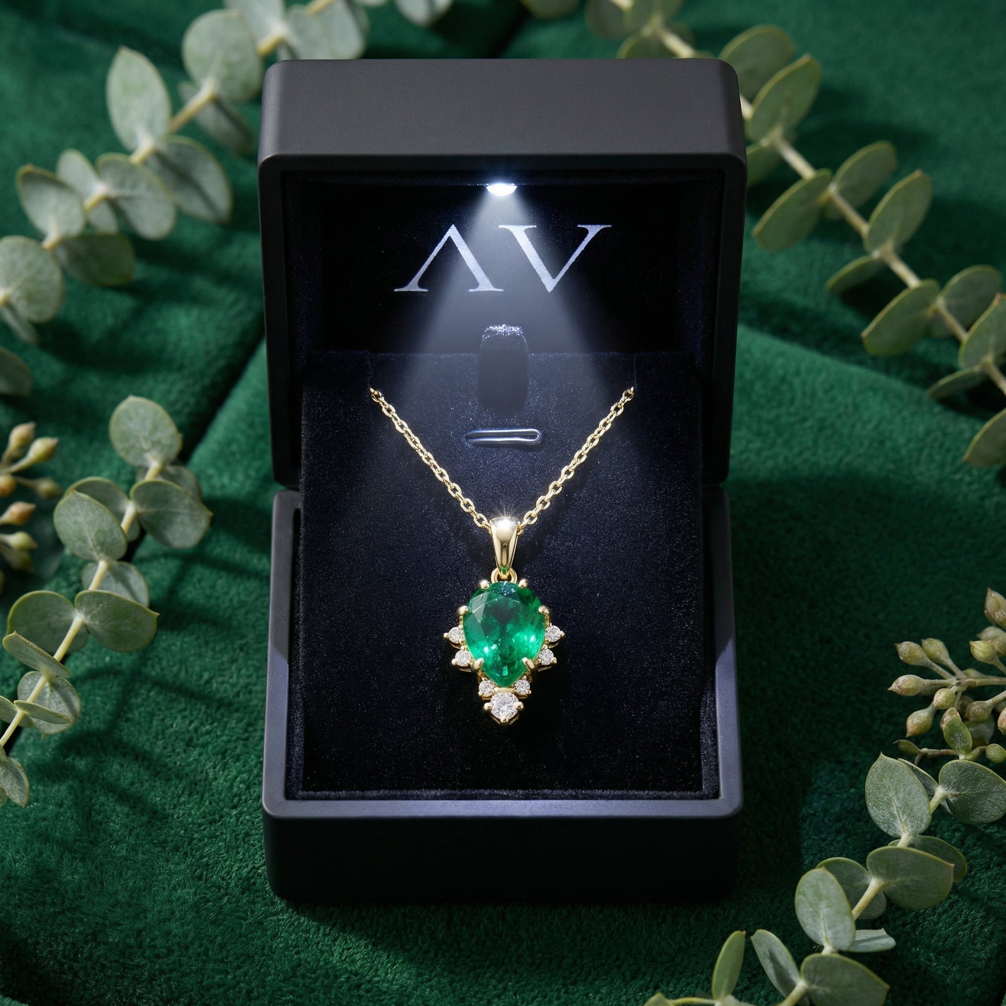 Pear-cut simulated emerald necklace in 18K gold vermeil presented in a lighted black jewelry gift box.