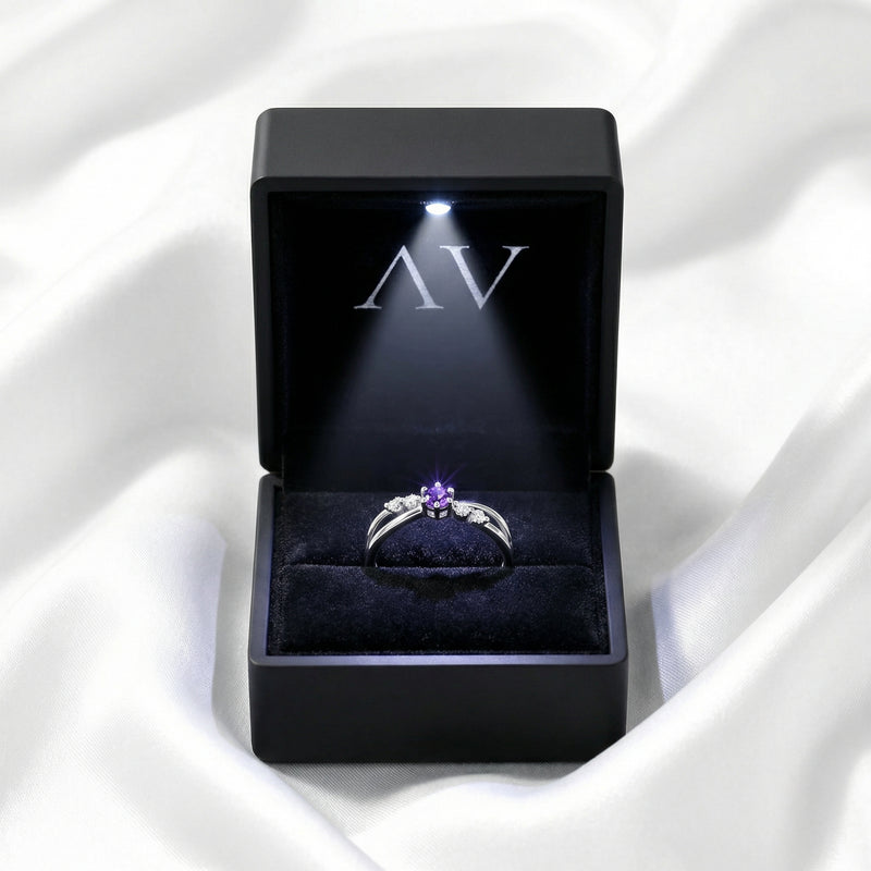 The Astraea sterling silver amethyst ring inside a black LED-lit jewelry gift box.