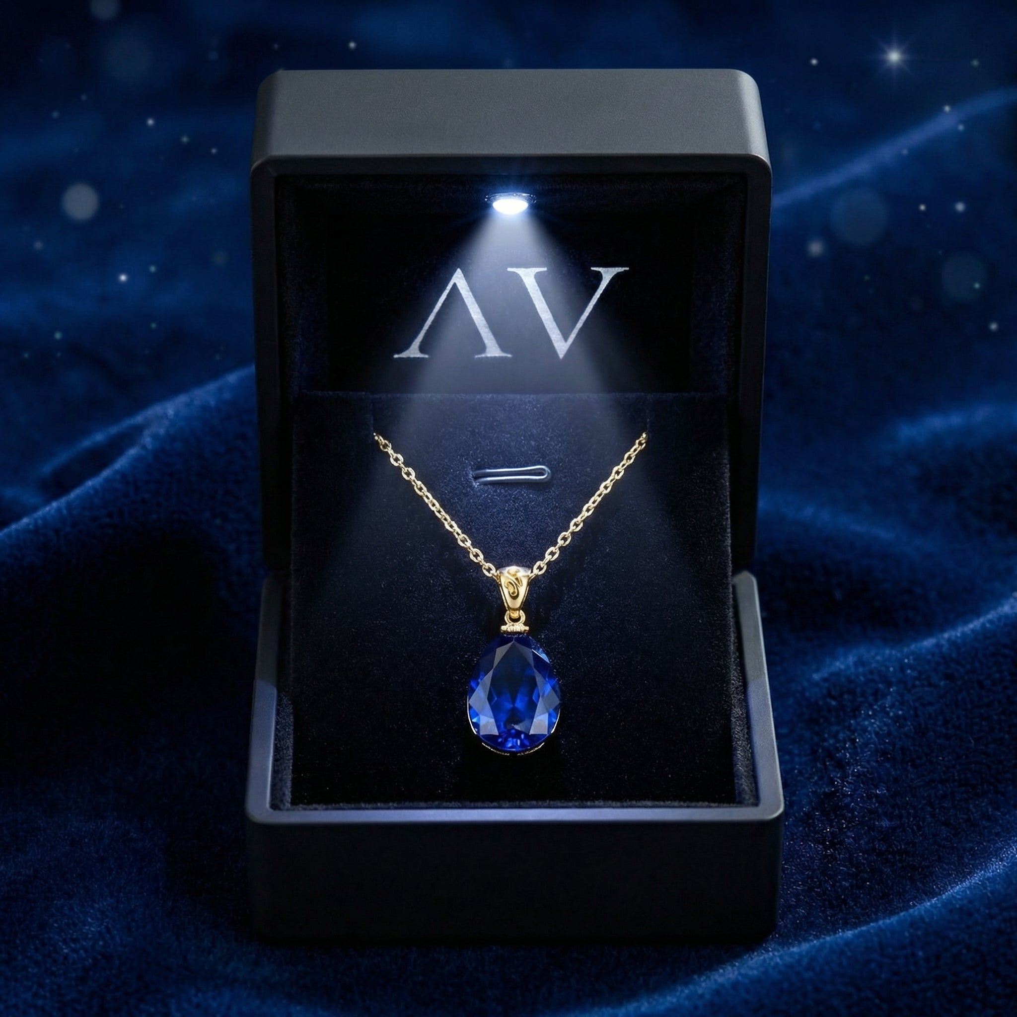 18K gold vermeil pear-cut simulated blue sapphire necklace inside a premium lighted black jewelry box.