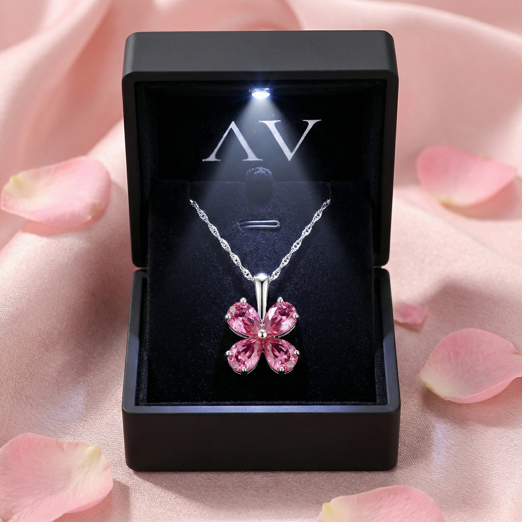 Petalina flower sterling silver necklace with pink tourmalines in a black LED-lit jewelry presentation box.