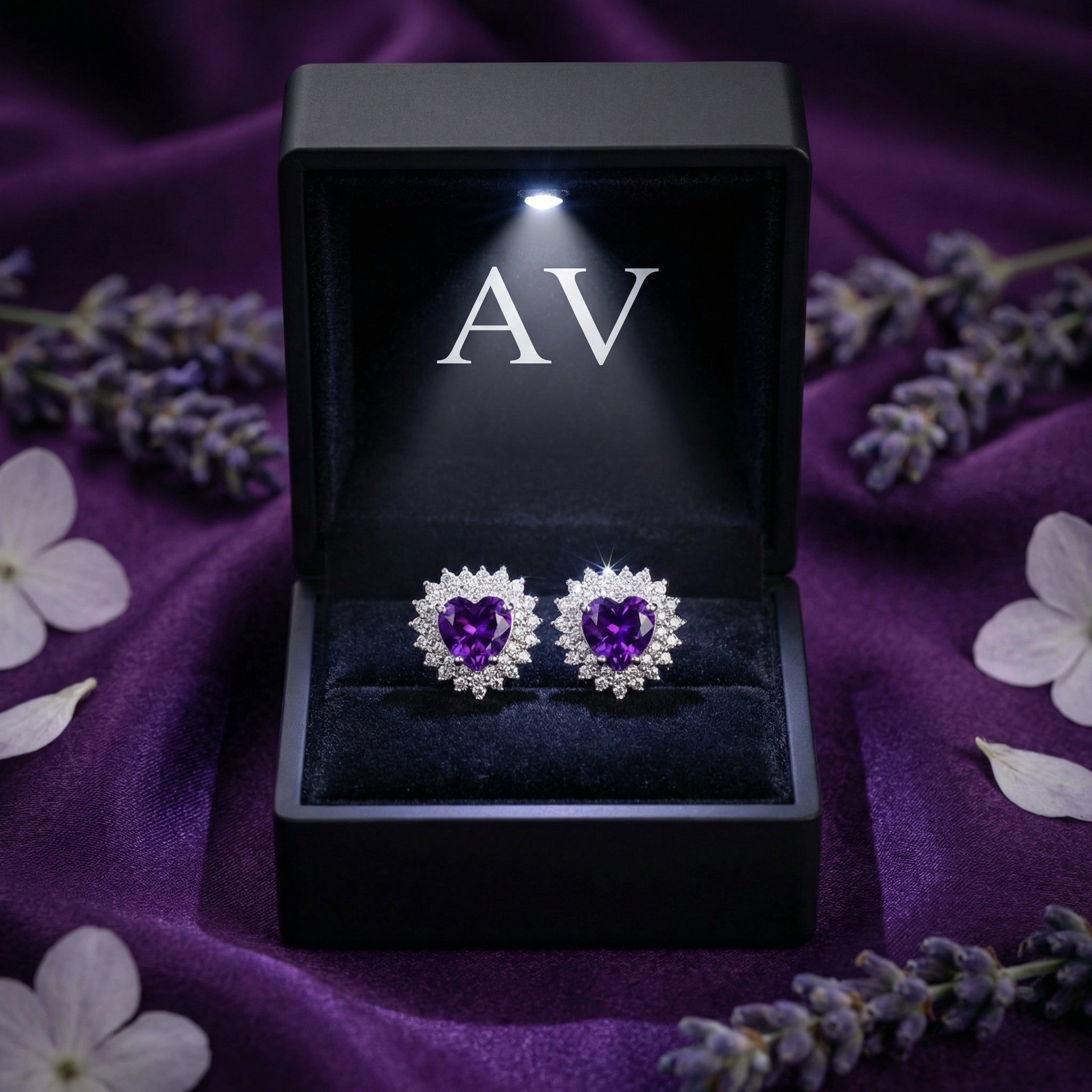 Heart cut amethyst earrings in sterling silver displayed in a black LED-lighted gift box with AV logo.
