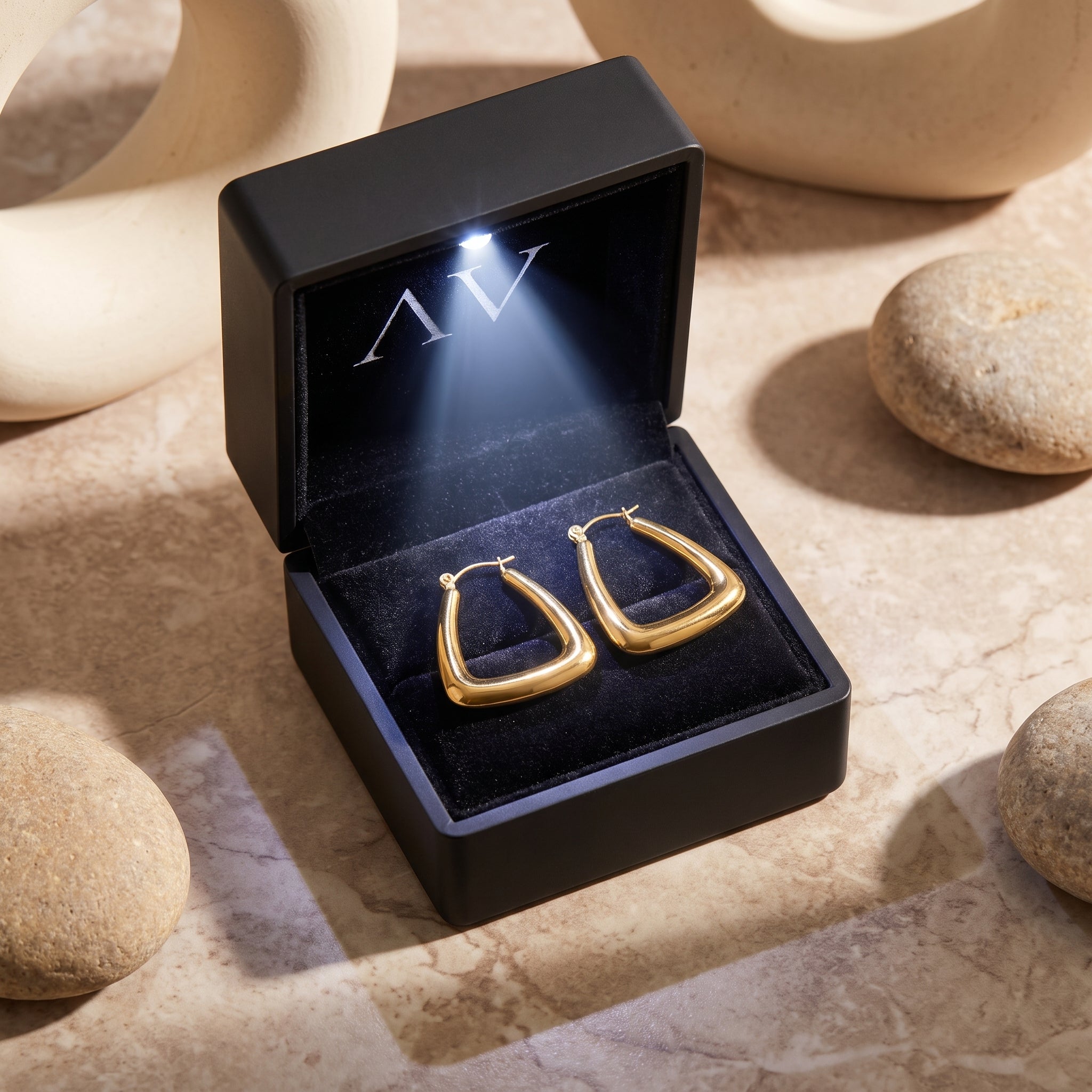 Gold 18K PVD stainless steel triangle hoops in LED jewelry box.