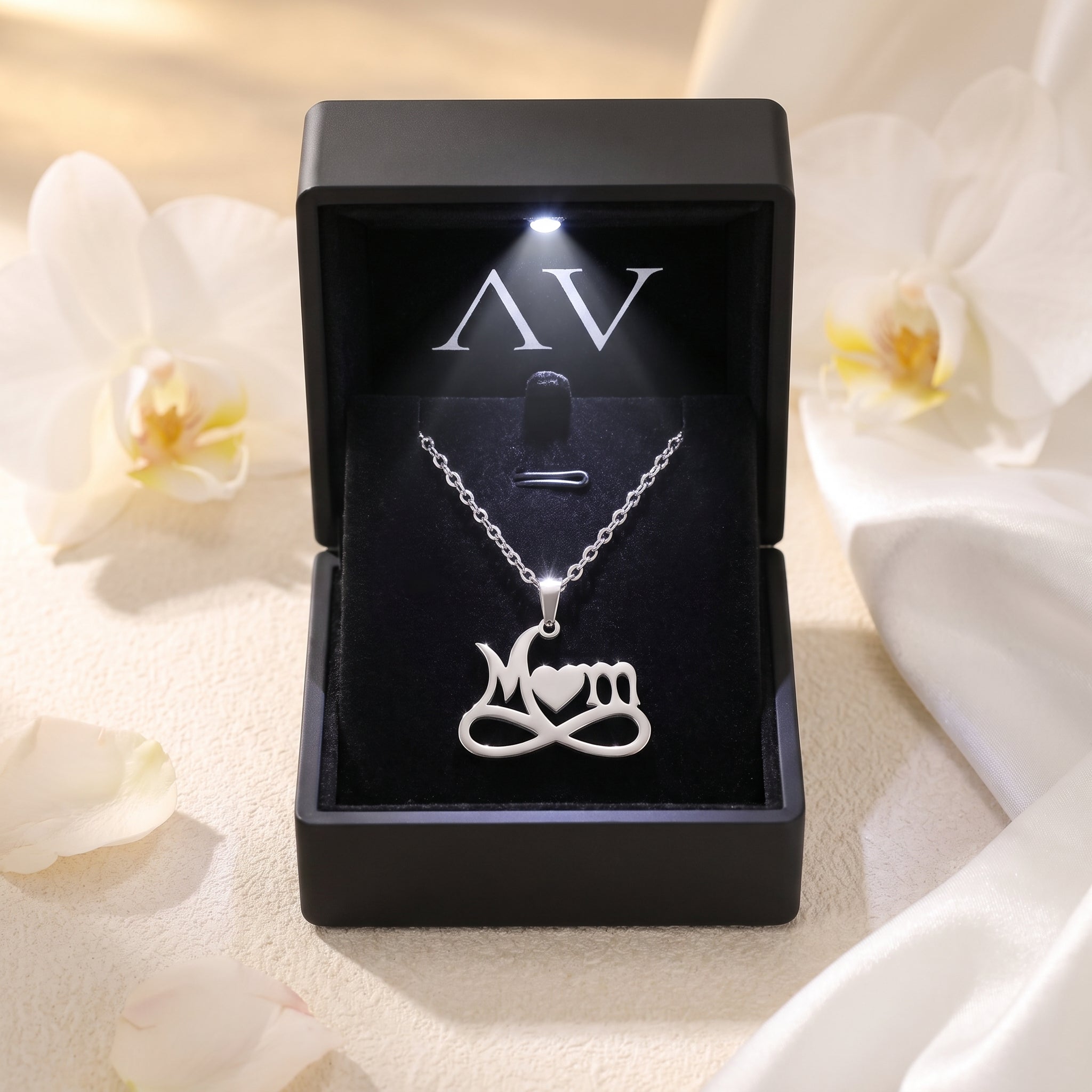 Silver stainless steel Mom infinity necklace in a lighted black gift box.