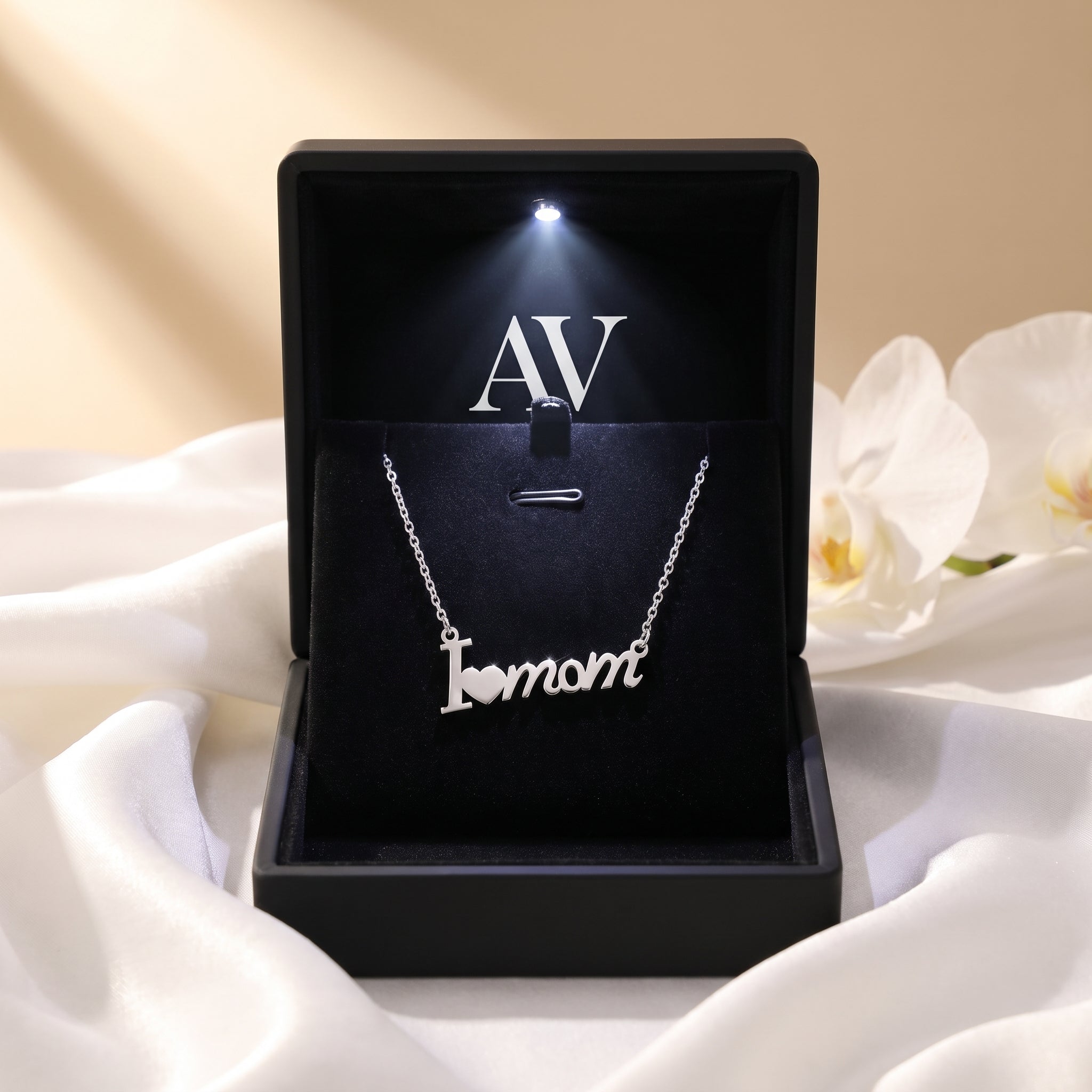 Silver 'I heart mom' necklace inside a black LED-lit presentation gift box.