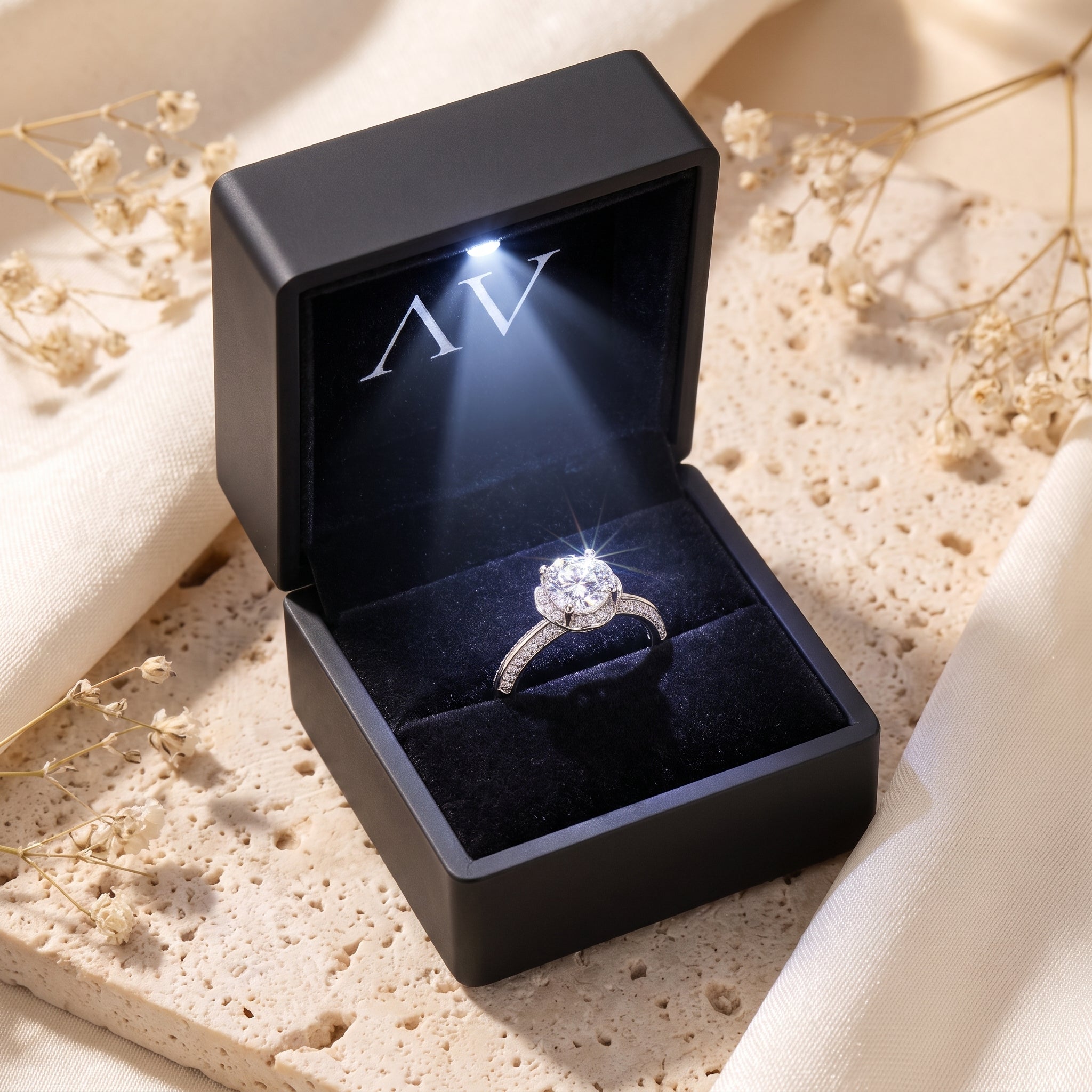 Silver simulated diamond ring in a black LED-lighted gift box.