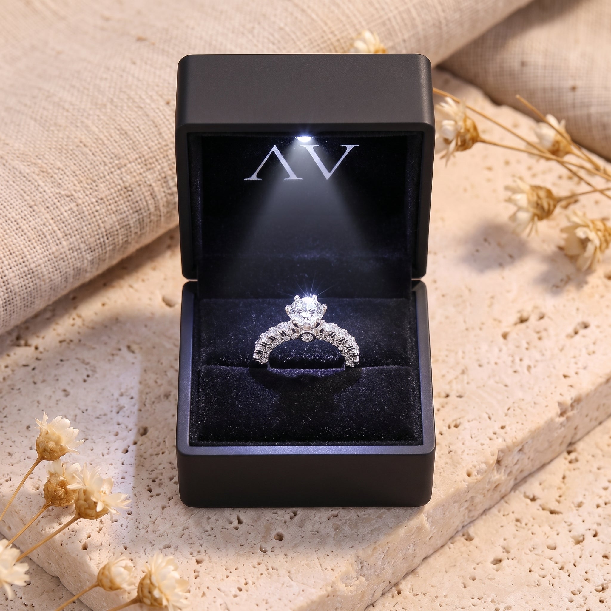 Silver cubic zirconia ring in a black LED-lighted gift box.