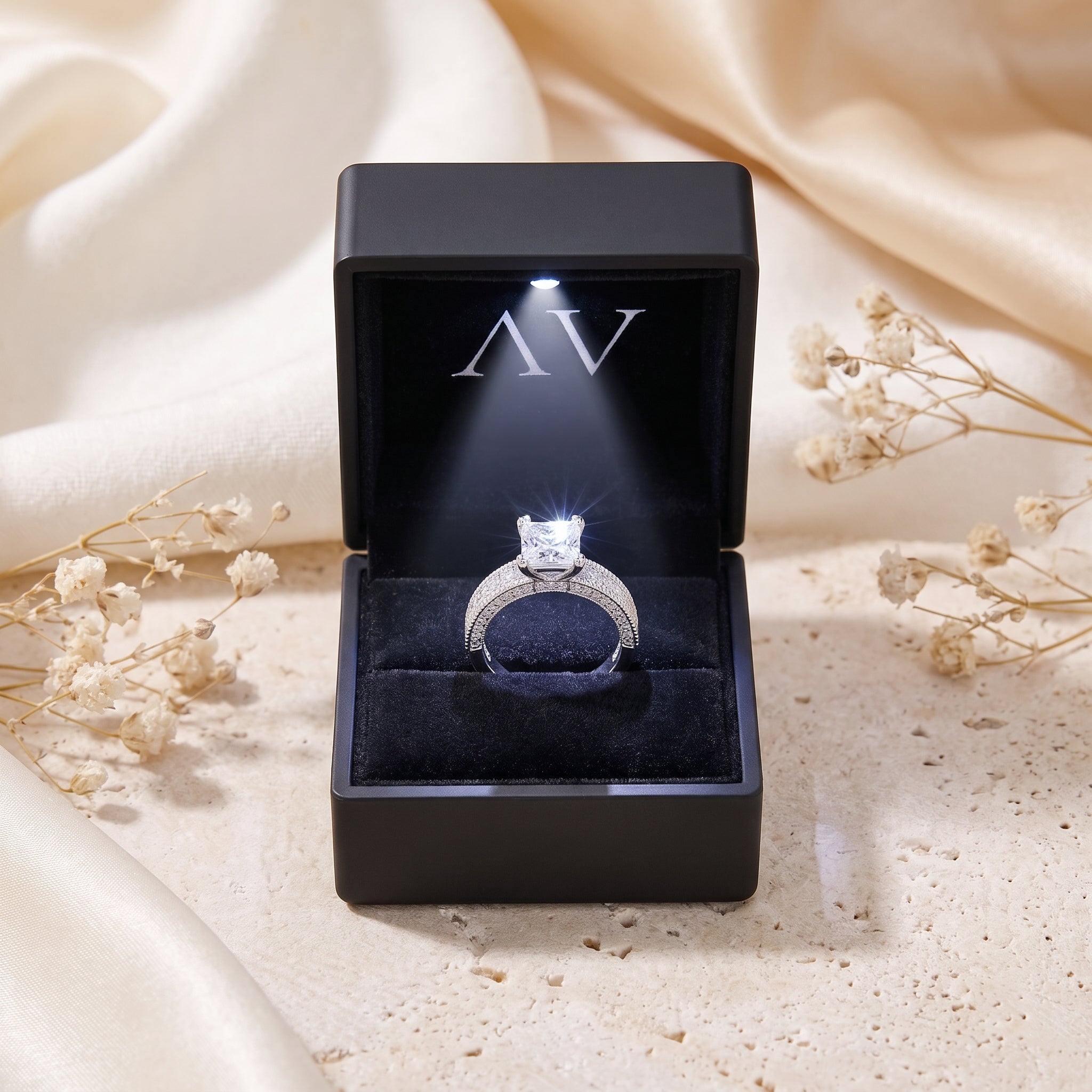 Princess cut CZ silver ring in LED-lit black gift box.