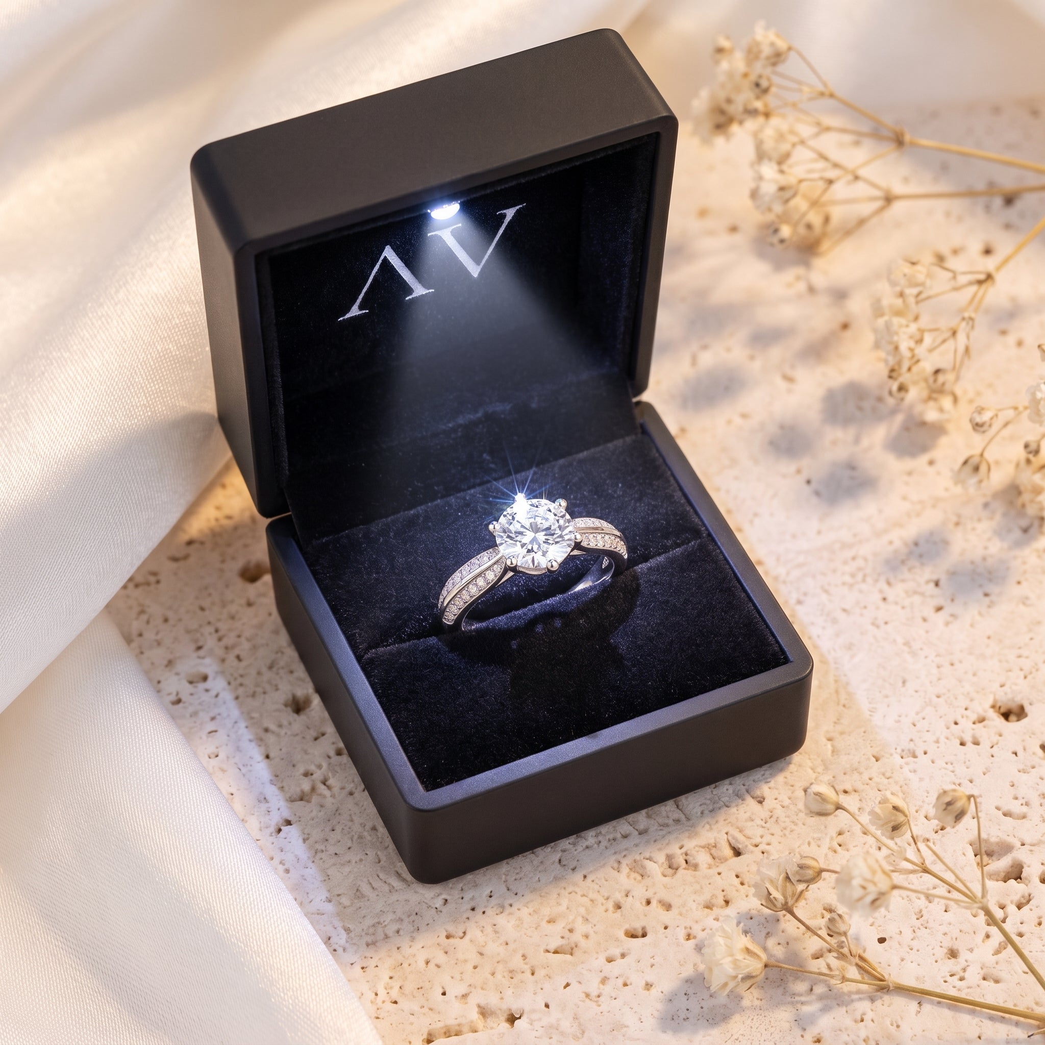 Aria round-cut simulated diamond ring in a black LED-lighted gift box.