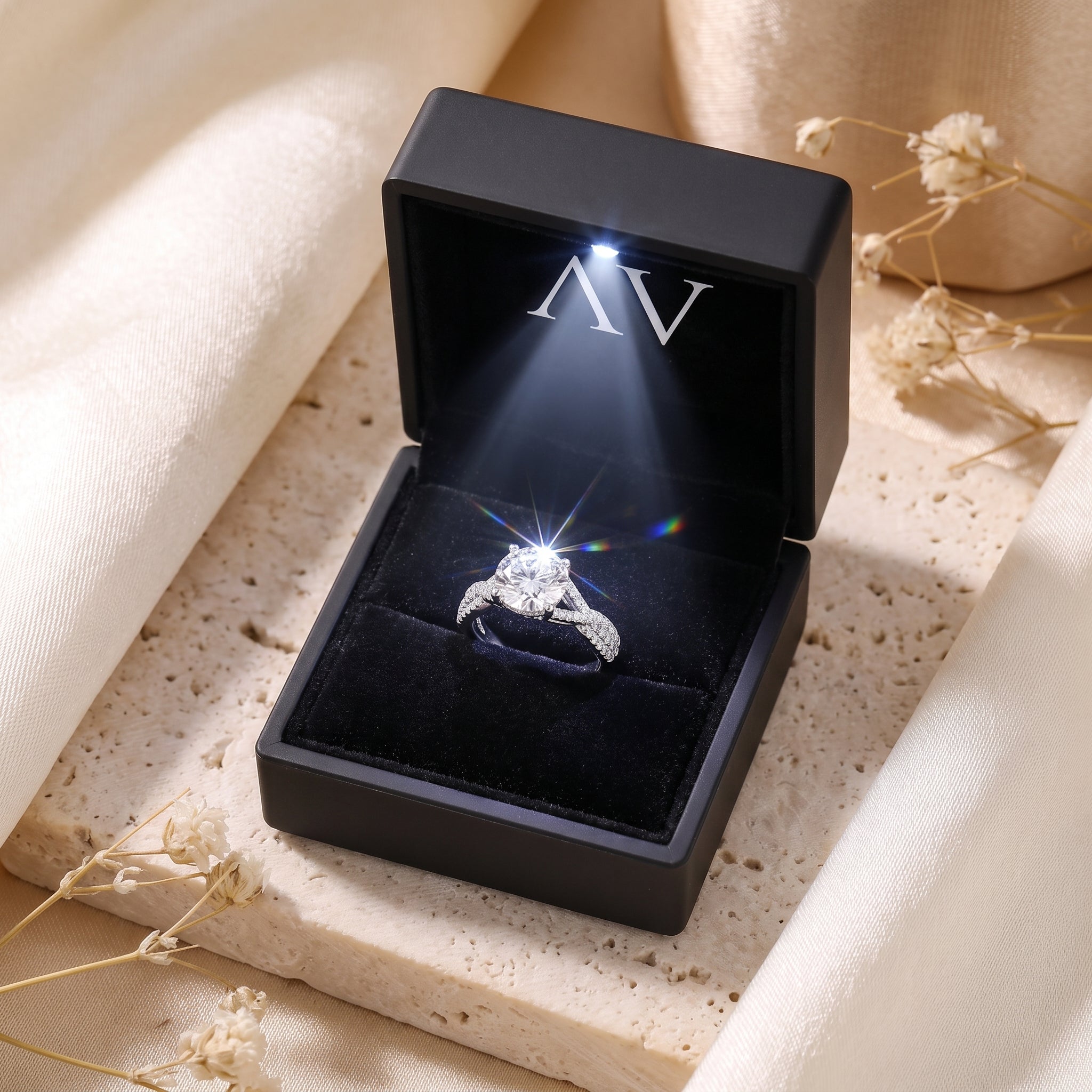 Sterling silver twisted solitaire ring in a lighted black gift box.