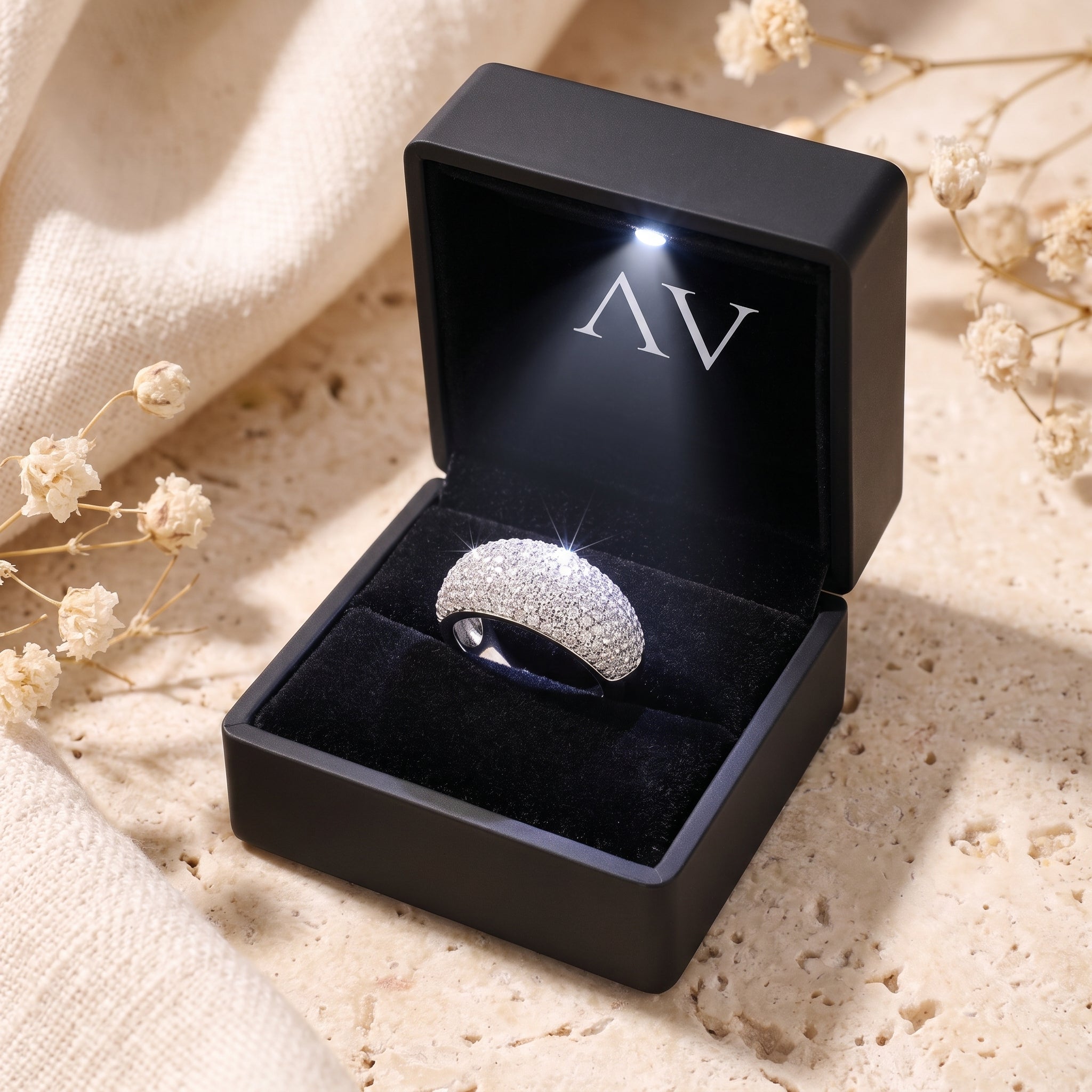 Silver pave dome ring in a black LED-lit gift box with brand logo.