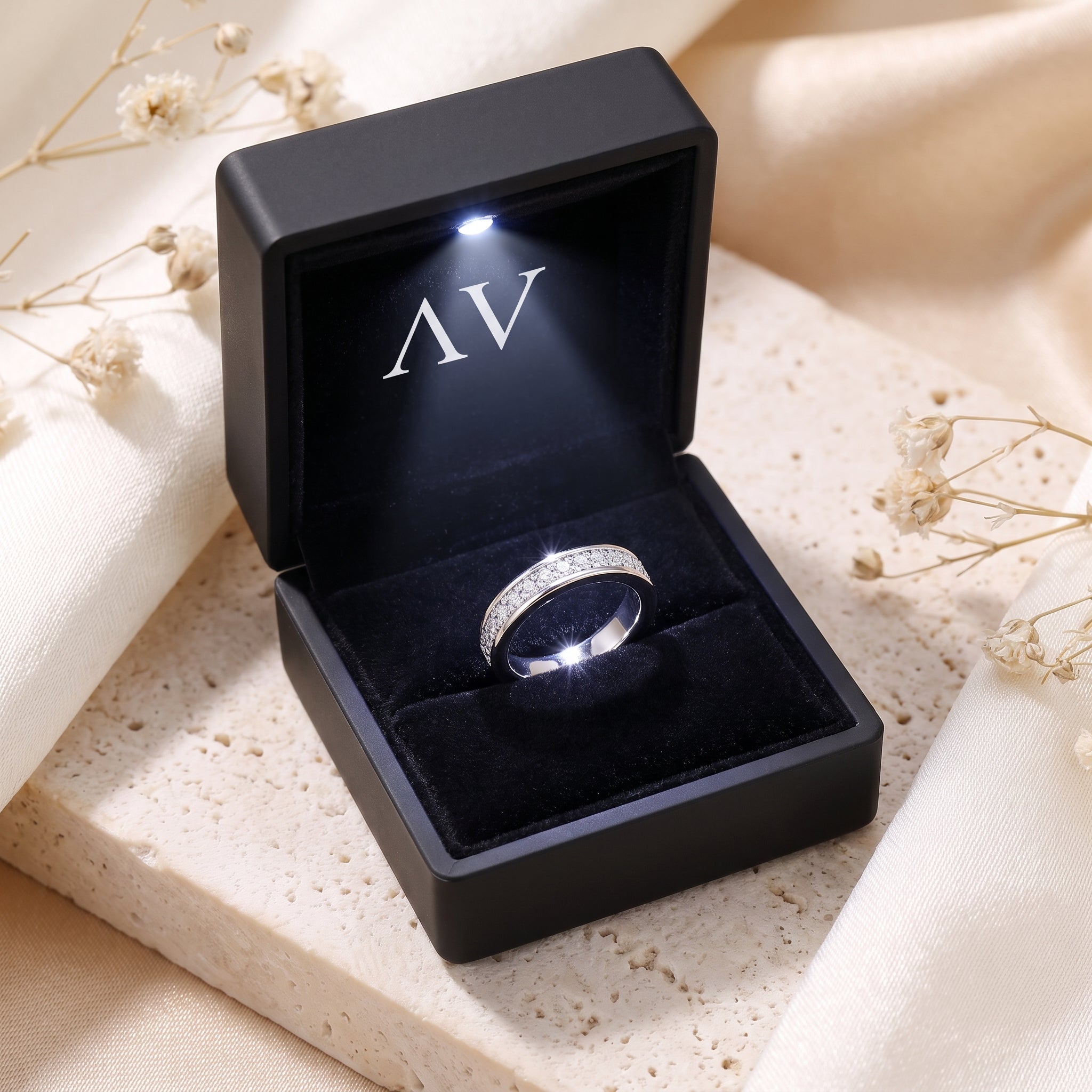 Double row pavé silver ring inside a black LED-lit jewelry gift box.