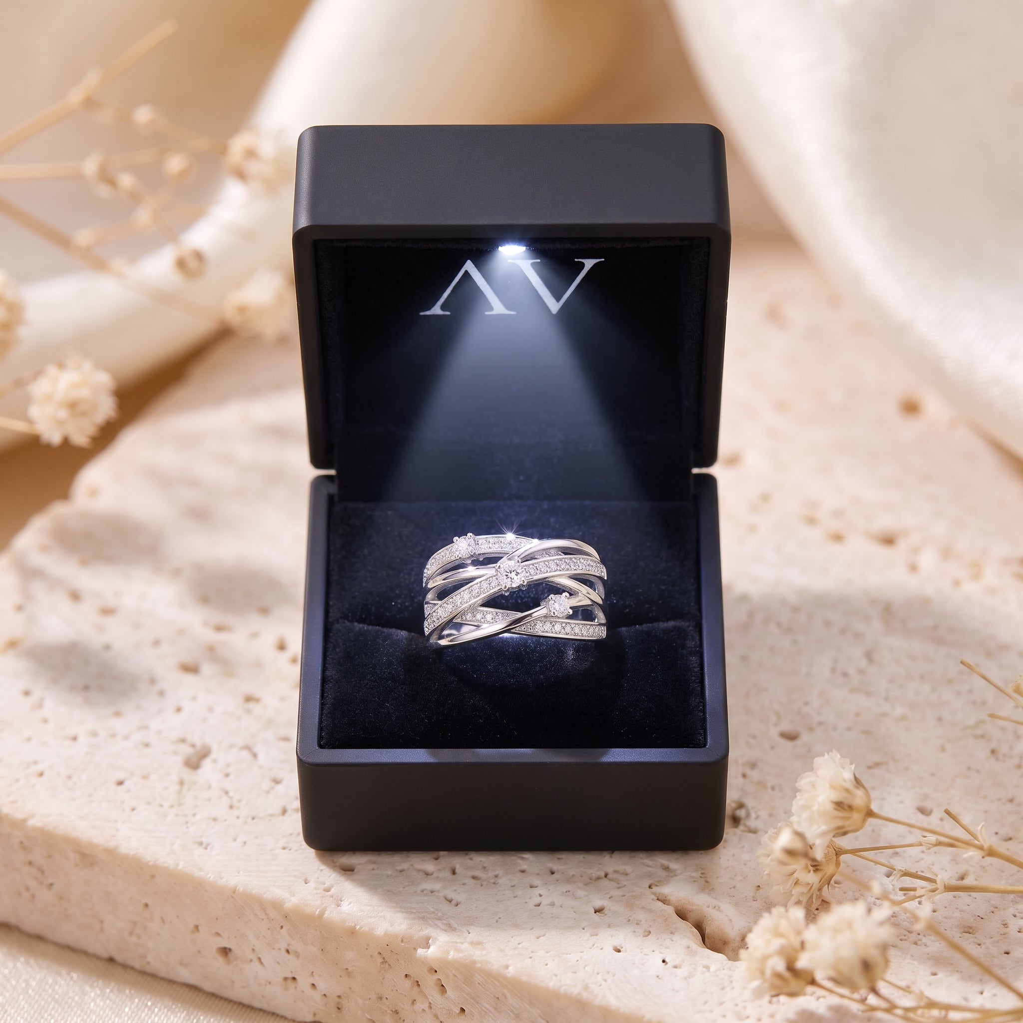 Sterling silver multi-row ring inside a black lighted gift box.