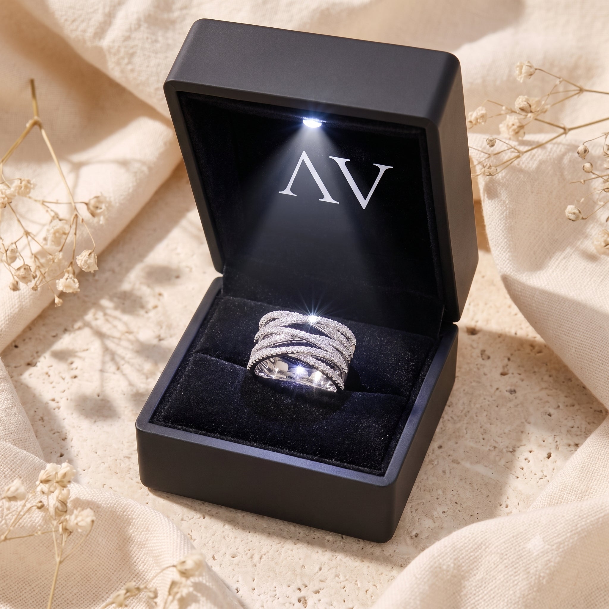 Nexus crossover ring inside a black LED-lit jewelry box.