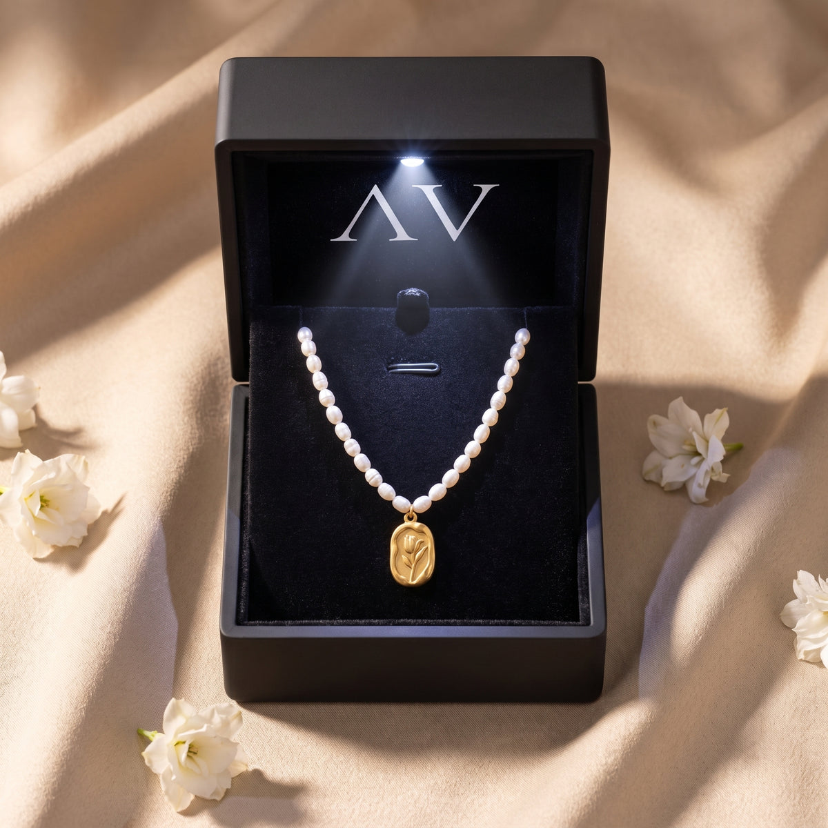 Rosalinde pearl necklace with gold rose pendant presented in a premium black lighted gift box.