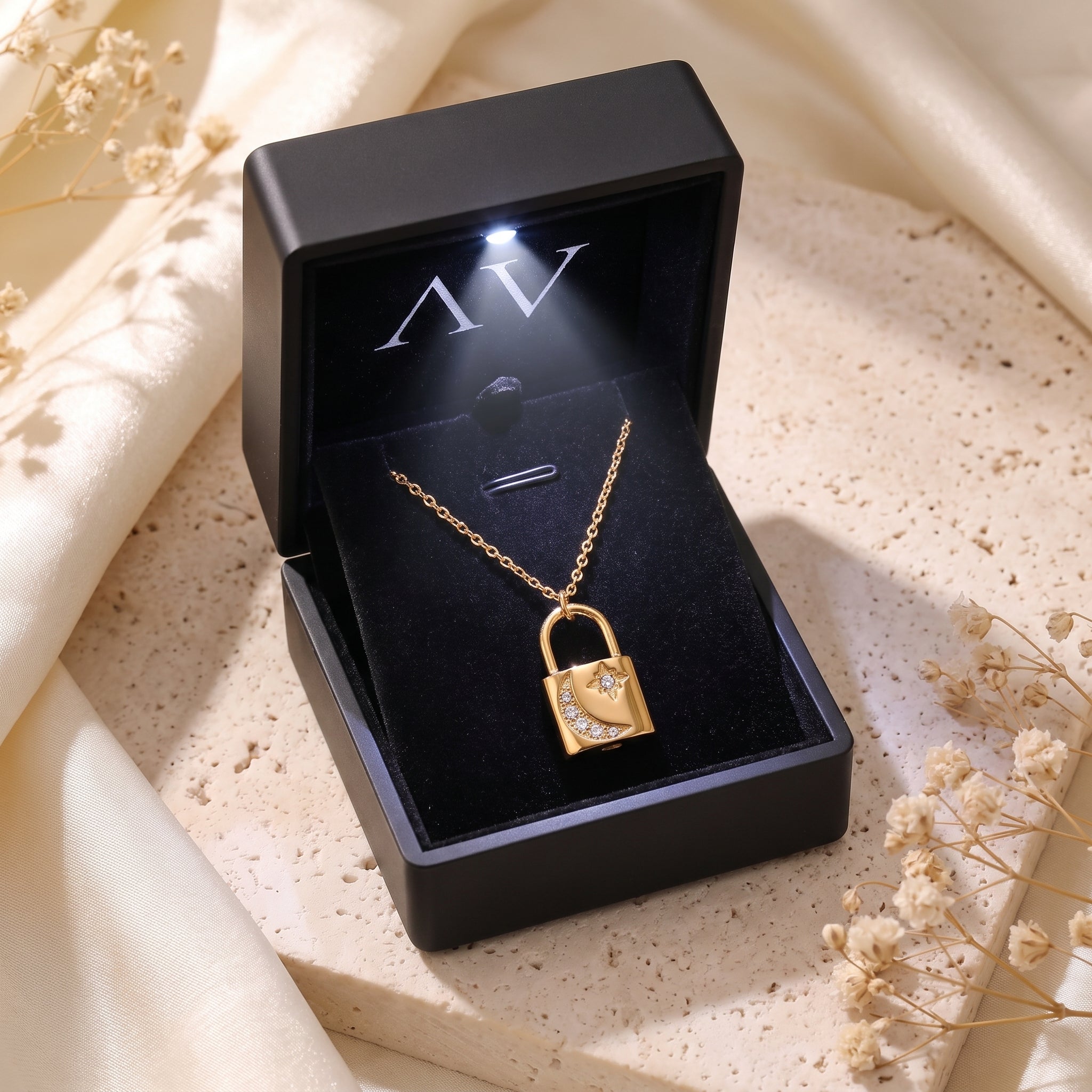 Gold padlock necklace displayed in a premium black LED-lit jewelry gift box.
