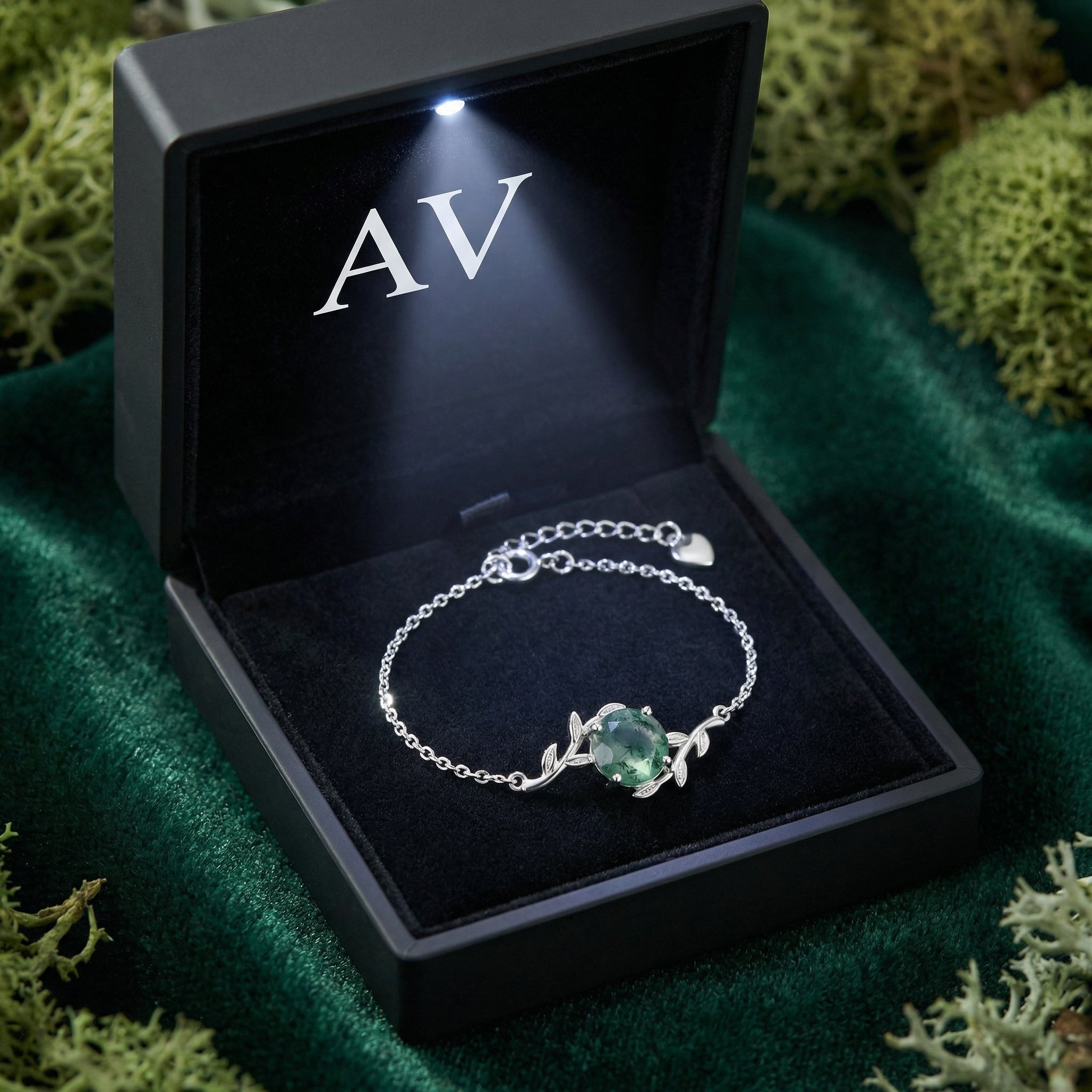 Sterling silver moss agate bracelet presented in a black lighted gift box with the AV logo on green velvet.