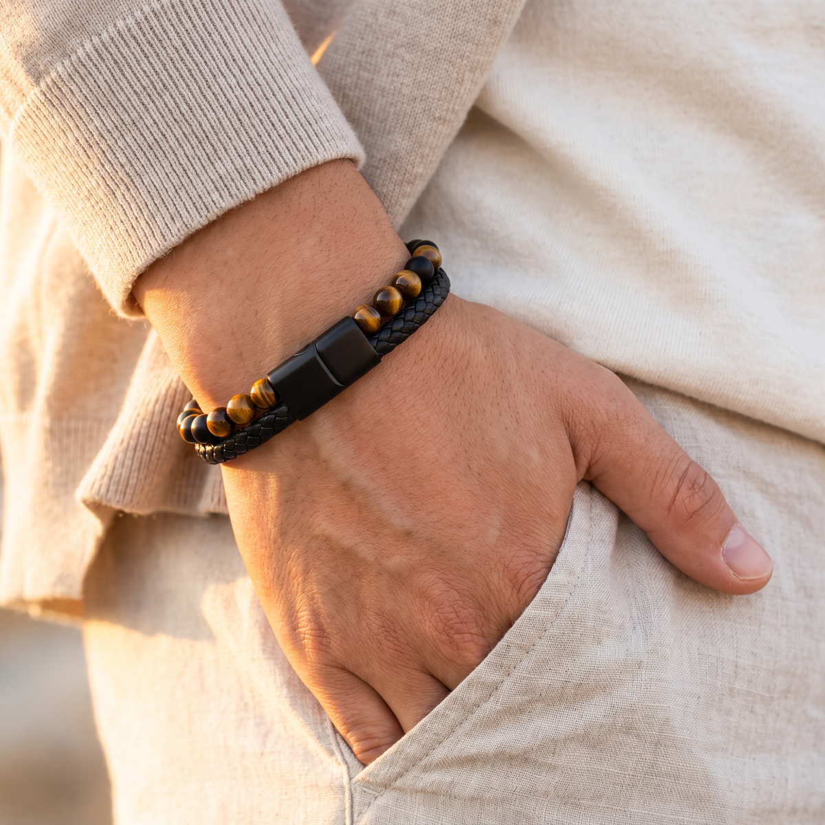 Personalized tiger eye and braided bracelet worn on a wrist