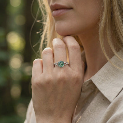 Model wearing a solid gold (white gold) hexagon moss agate ring with moissanite accents.