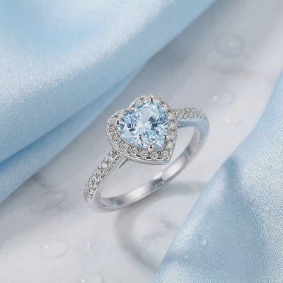 Simulated aquamarine heart halo ring in solid gold.
